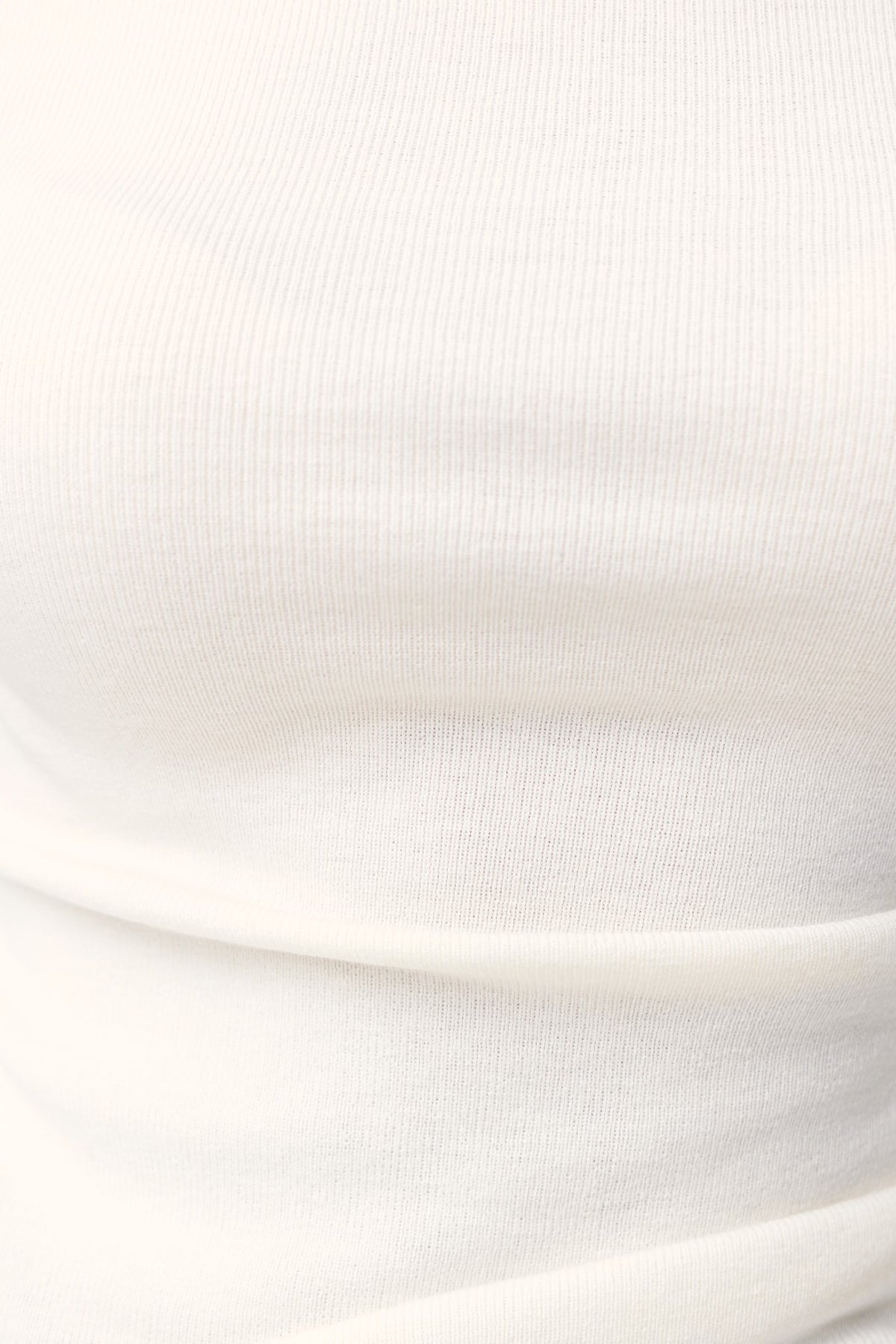 Close-up of Isla Top in knit material showing asymmetric neckline and texture, designed for comfort with stretch.
