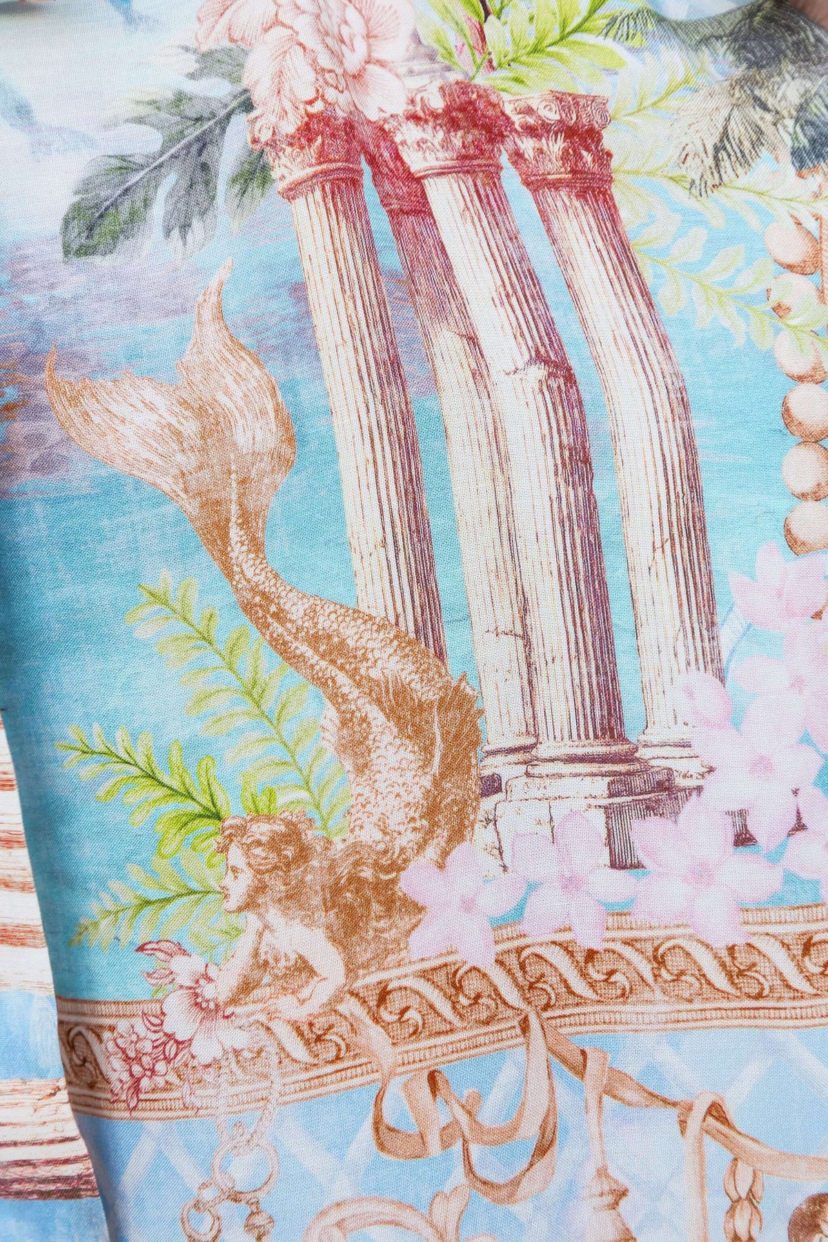 Close-up view of the print on the Island Escape Jumpsuit featuring mermaid and architectural designs.
