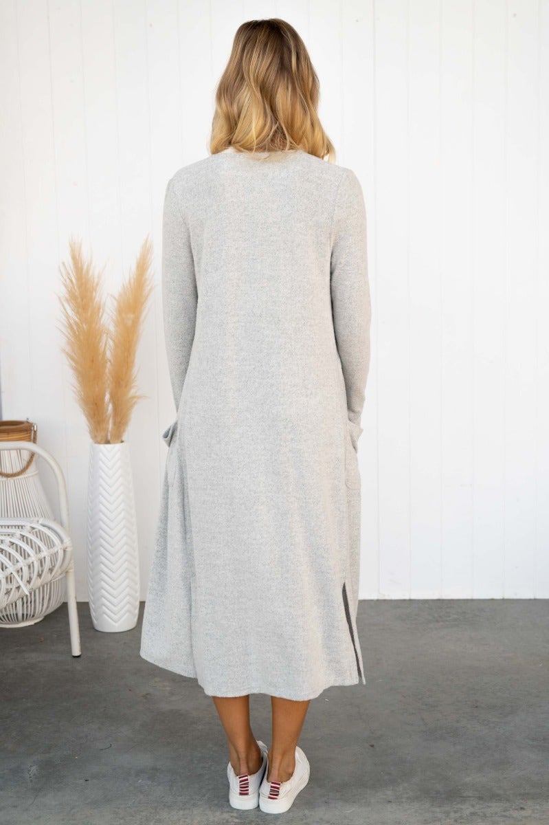 Back view of a gray Izzy Cardigan featuring textured knit, side pockets, and short side slits.