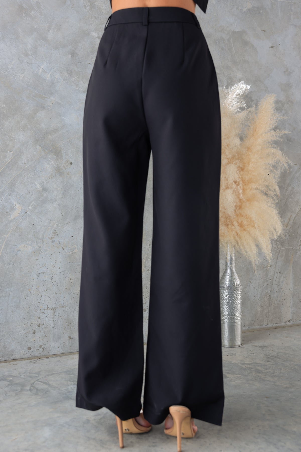Josefina Pants in black with mid-high waist fit, non-lined, and wide leg design. Ideal for versatile wardrobe styling.