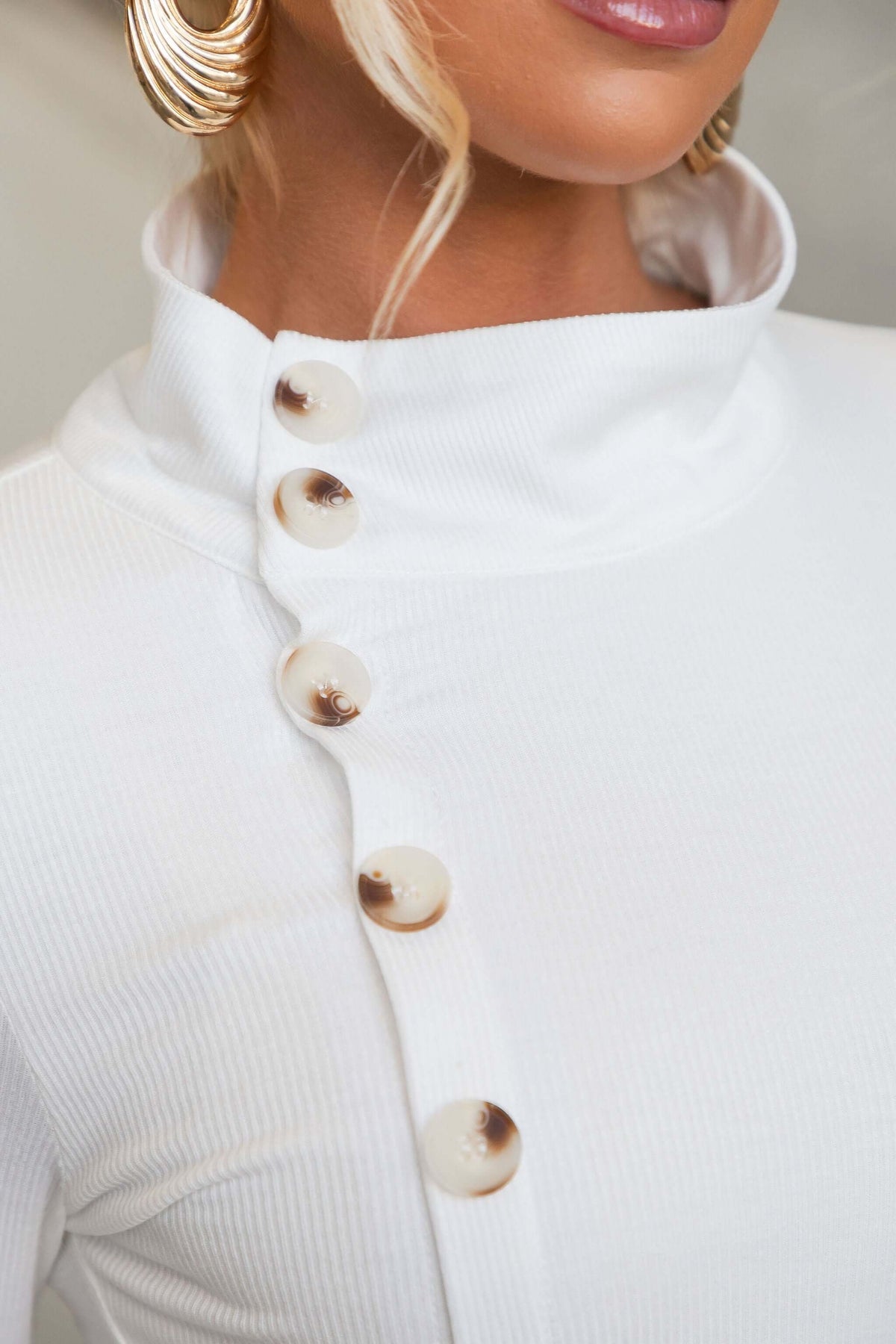 Close-up of Josia Top showcasing the round neckline and faux button-up front detail.