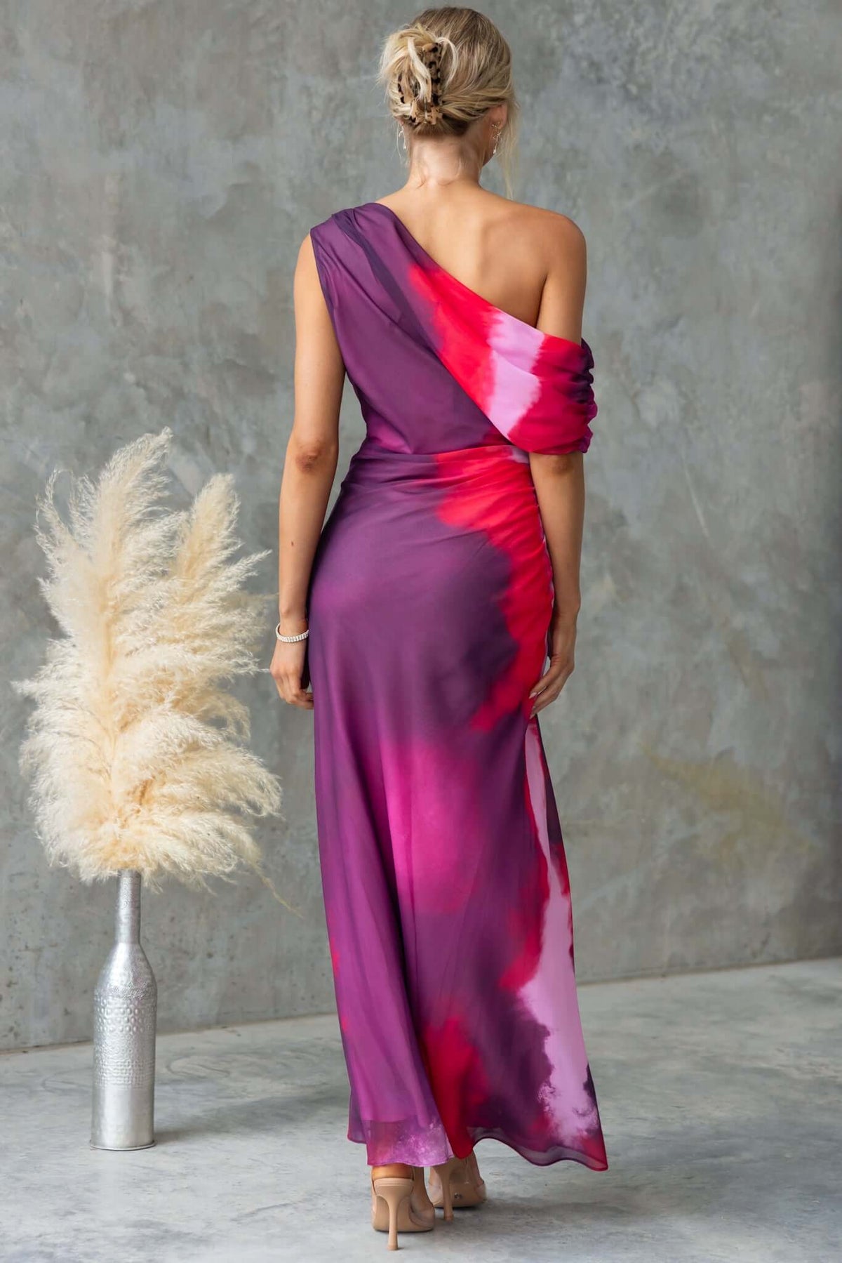 Jules Maxi Dress with asymmetric neckline, side ruching, and vibrant tie-dye pattern, perfect for elegant occasions.