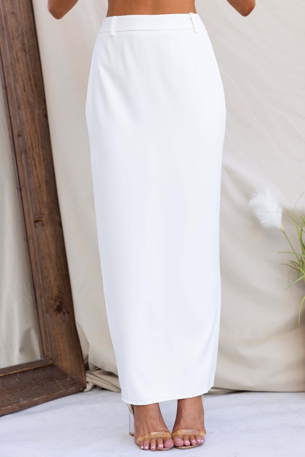 Julien Maxi Skirt in white, featuring a mid-high waist, invisible zip, and back split for stylish comfort.