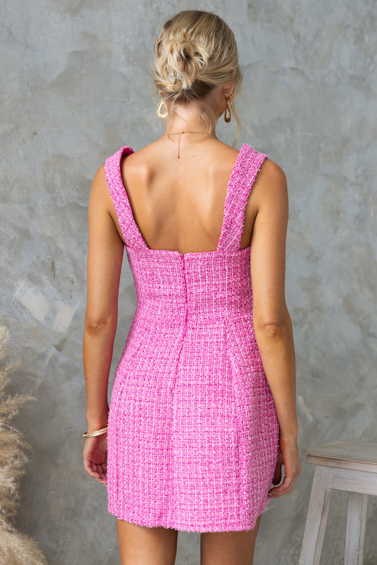 Back view of the Junnie Dress featuring a square neckline, invisible zip, and faux pockets in soft pink chenille fabric.