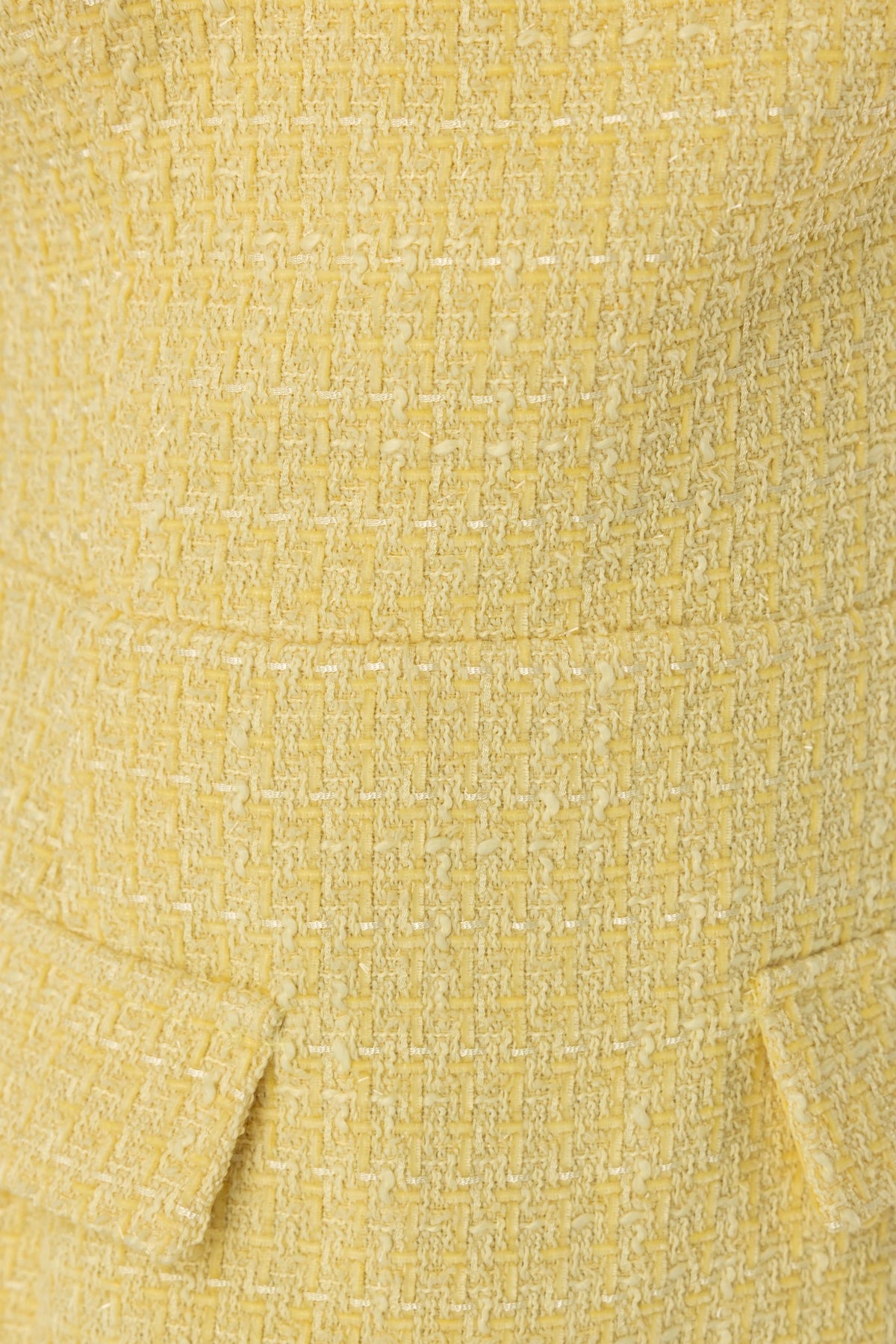 Close-up of yellow chenille fabric with faux pockets on the Junnie Dress, showcasing textured detail.