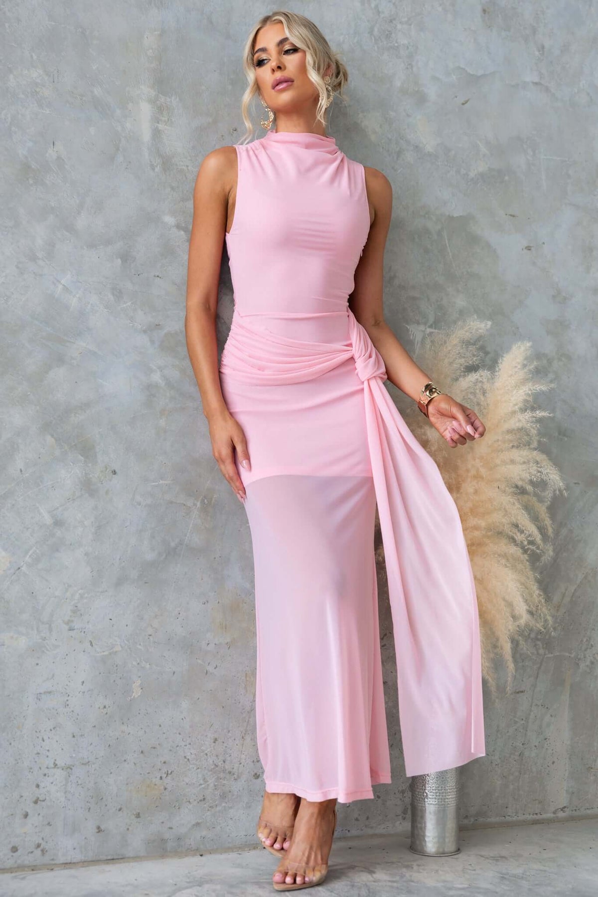 Karter Maxi Dress in soft pink with high neckline, side zip, draped waist, and flowing mesh material, perfect for elegant occasions.