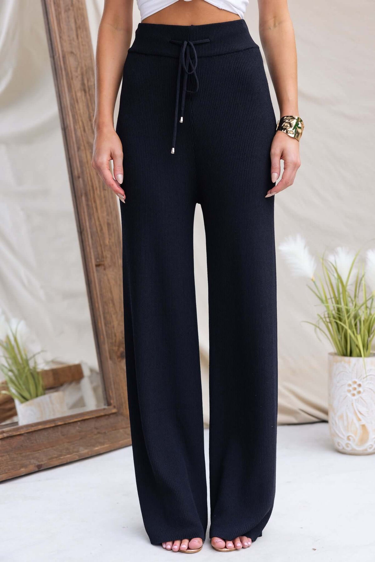 Keene Pants in black, featuring mid-high waist, elastic drawstring, made from stretch knit ribbed material.