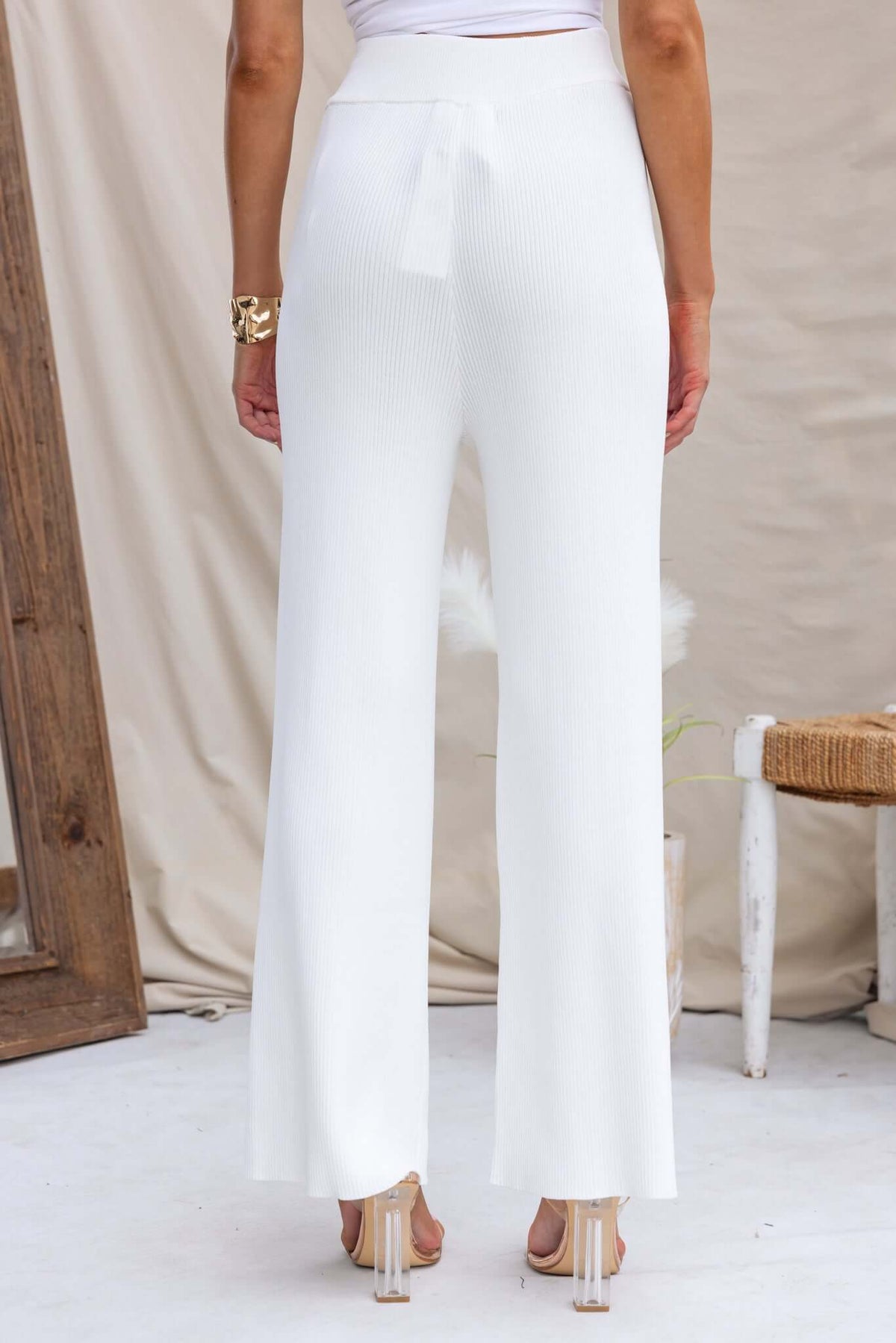 Back view of white Keene Pants featuring a mid-high waist fit and elastic waistband with drawstring.