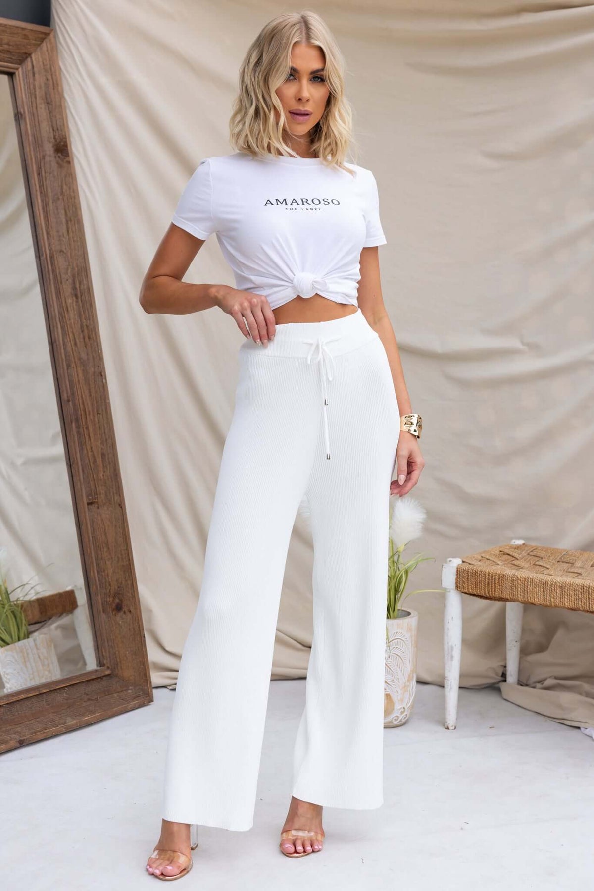 Model wearing Keene Pants with mid-high waist and elastic drawstring in white, styled with a cropped top.