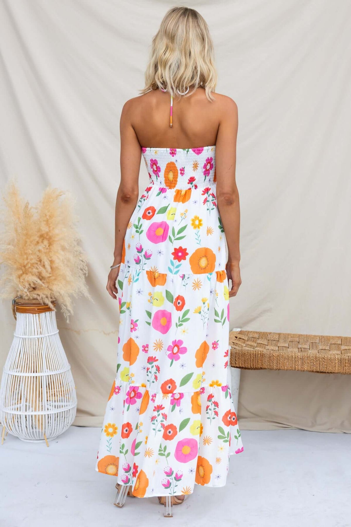 Back view of a floral Kelce Maxi Dress with tie neckline, showcasing vibrant colors and a flowing silhouette.