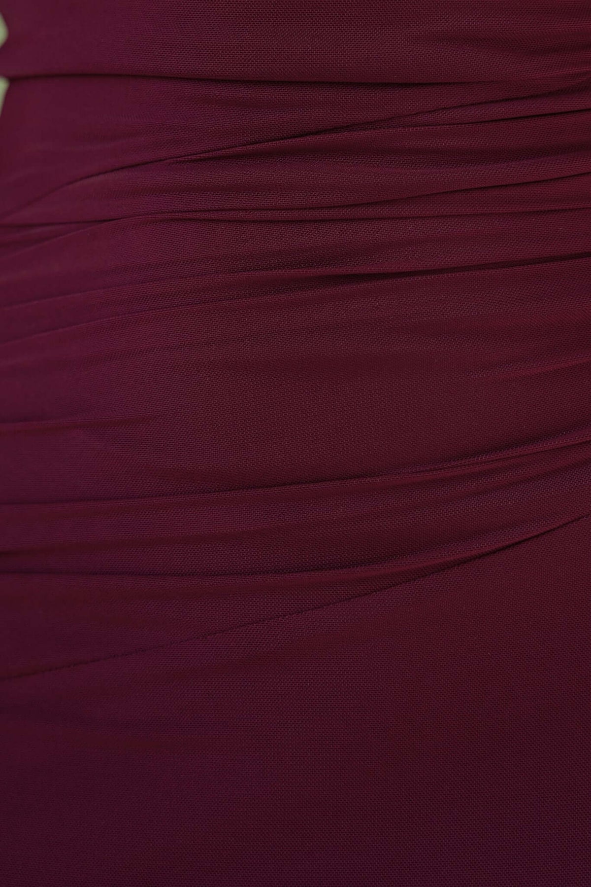 Close-up of the Korren Maxi Dress fabric showing detailed ruching in a rich burgundy color.