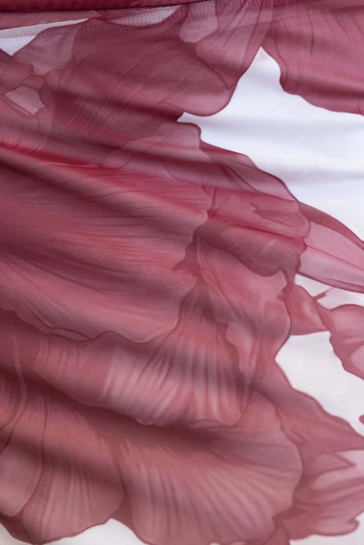Close-up of the floral print on the Korren Maxi Dress in soft pink and maroon tones.