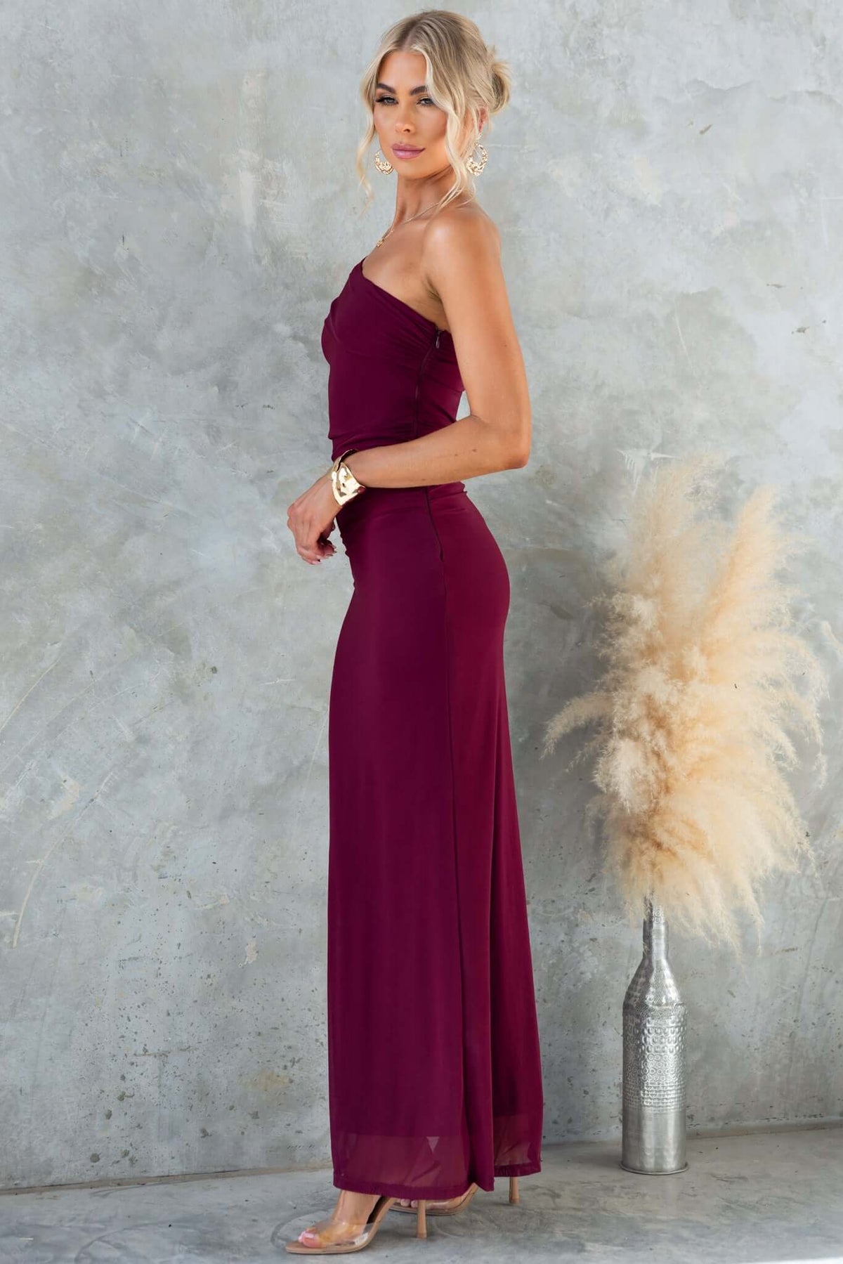 Korren Maxi Dress in burgundy, featuring a one-shoulder neckline and side zip, perfect for formal occasions.