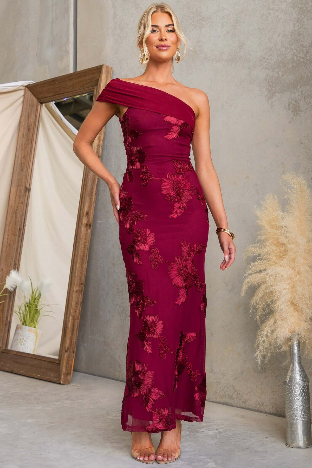 Korren Maxi Dress featuring a one-shoulder neckline and embroidered mesh material in burgundy.