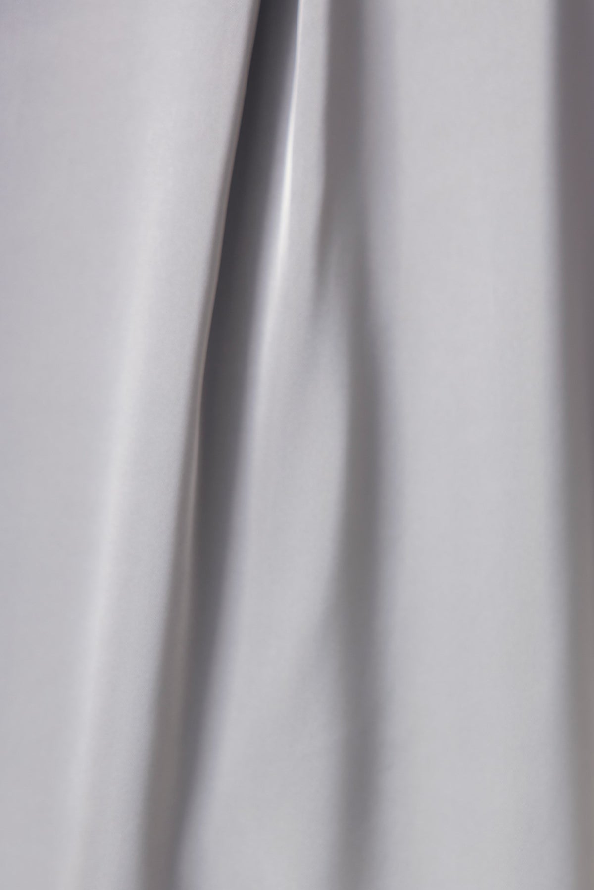 Kortez Shirt fabric close-up showing smooth satin texture and gray color, perfect for a stylish button-up shirt.