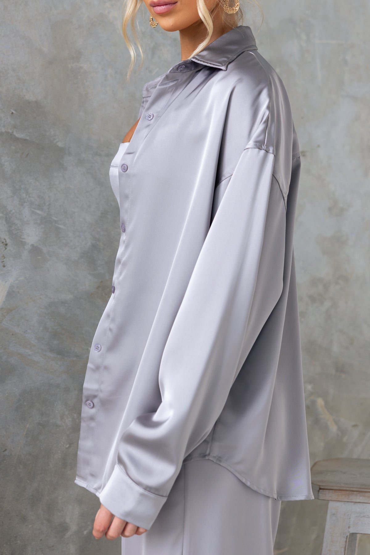 Kortez Shirt in silver satin, featuring a collar and button-up front, shown with a relaxed fit on a model.