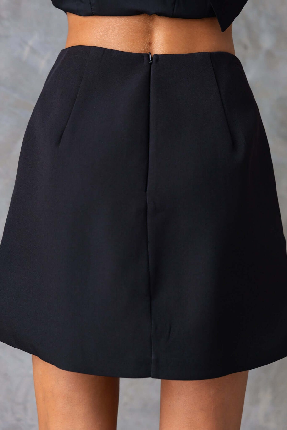 Laredo Skirt featuring a mid-high waist, invisible back zip, and lined 100% polyester fabric.