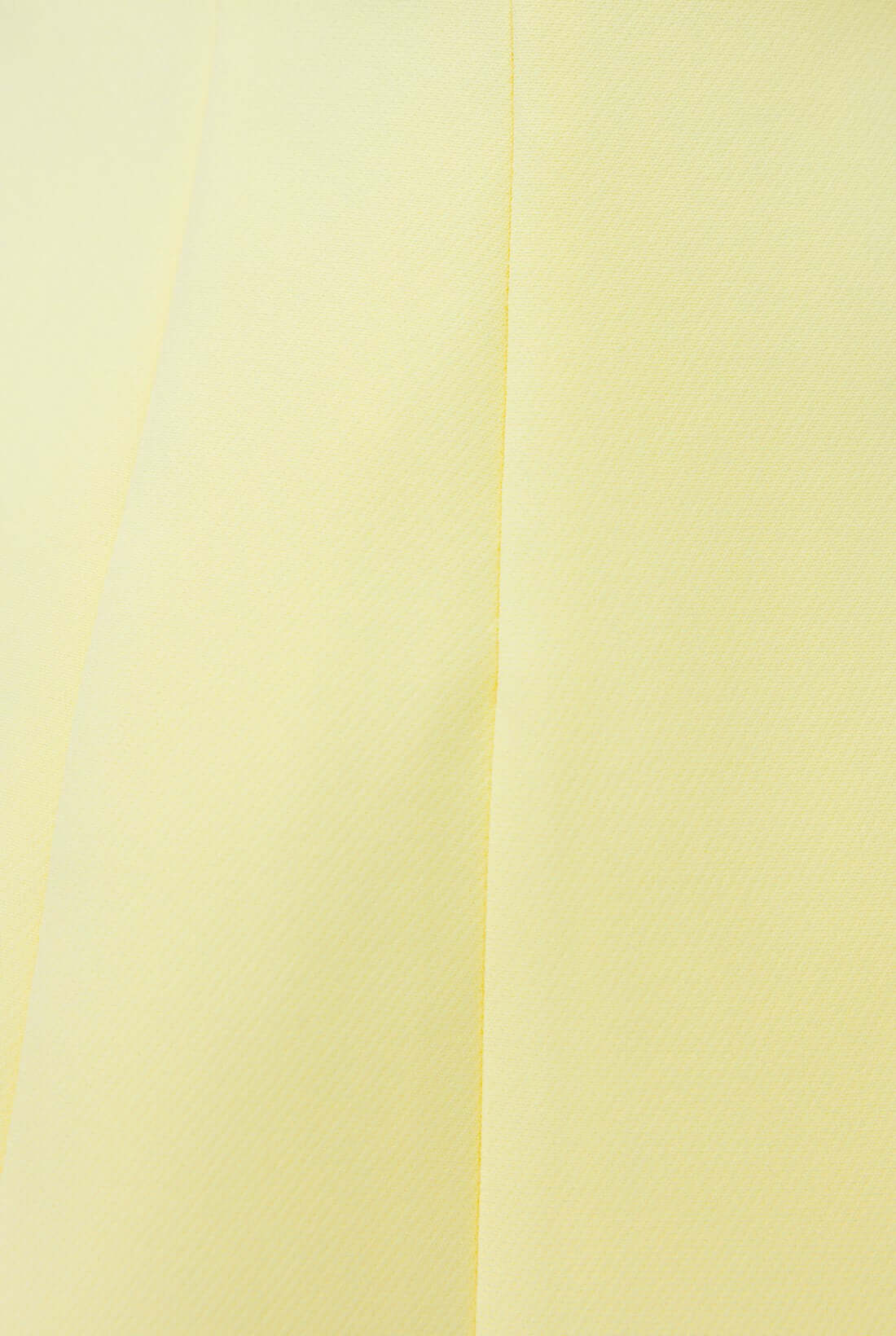 Close-up of Laredo Top in light yellow showing fabric texture and color detail, featuring a smooth polyester design.