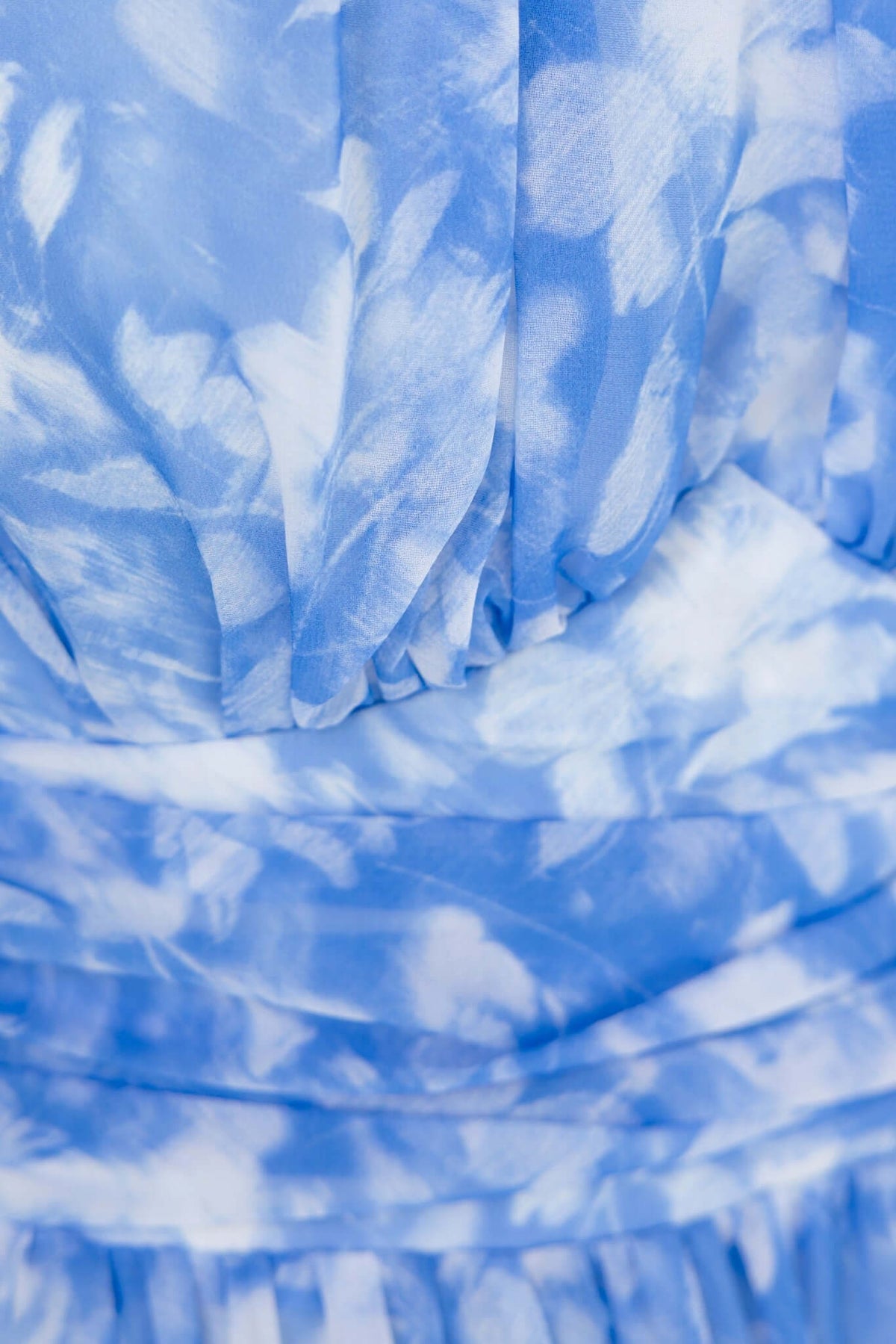 Close-up of soft blue floral fabric of the Little Things Maxi Dress, showcasing the elegant texture and design.