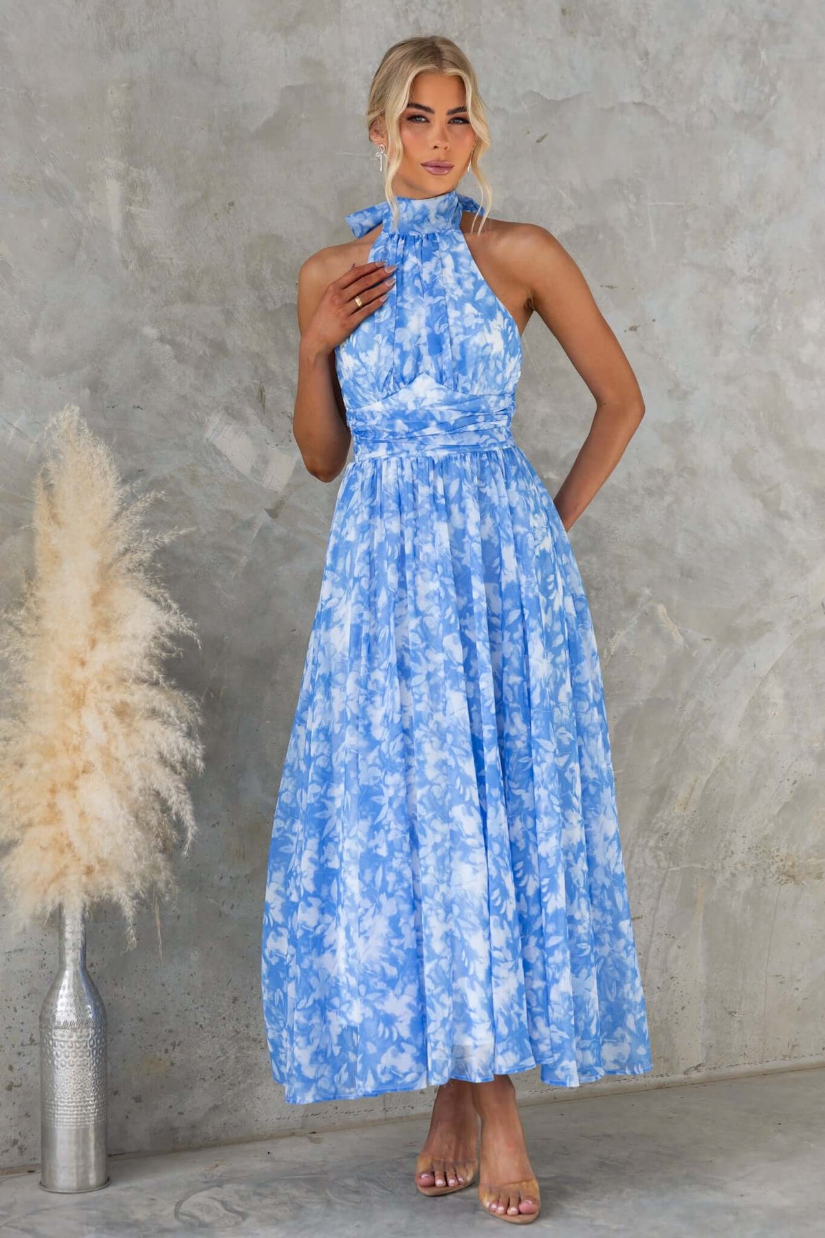 Blue floral maxi dress with high tie neckline and invisible zip, perfect for elegant occasions.