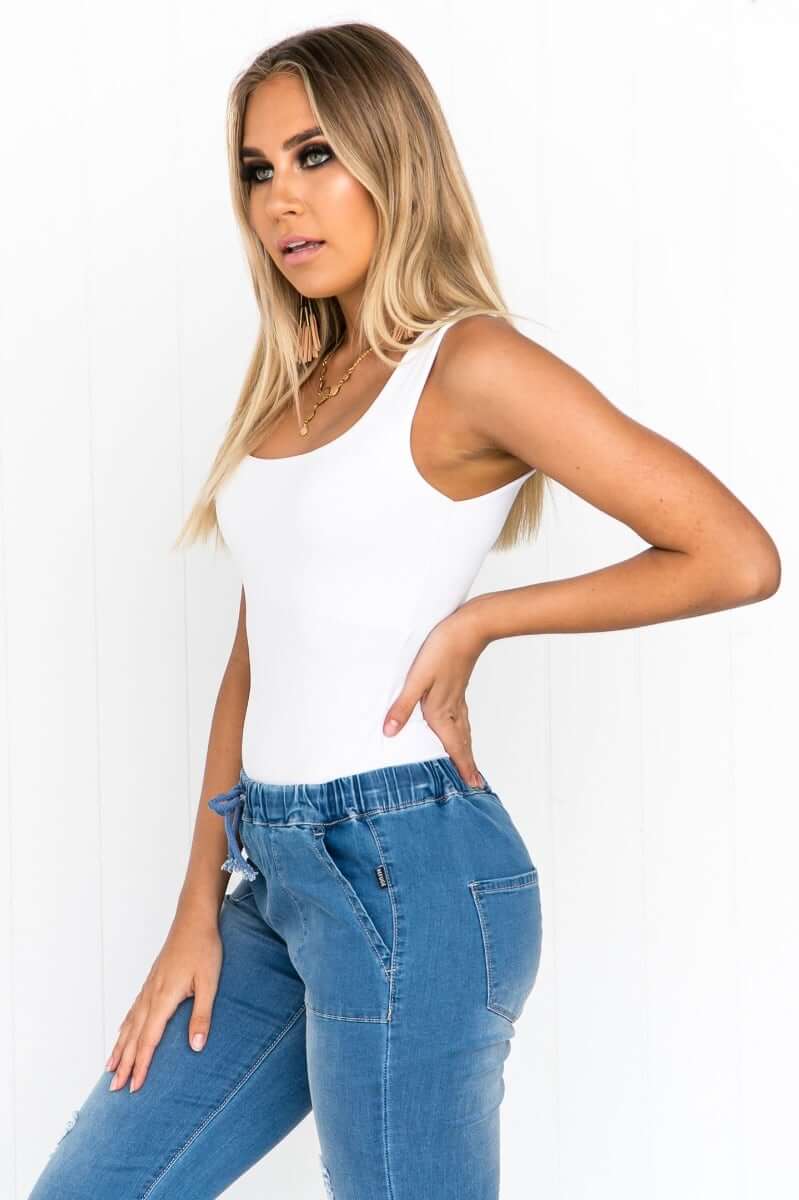 Model wearing Layla Top by Amaroso in ice white, featuring a wide scoop neckline and Lycra feel material.