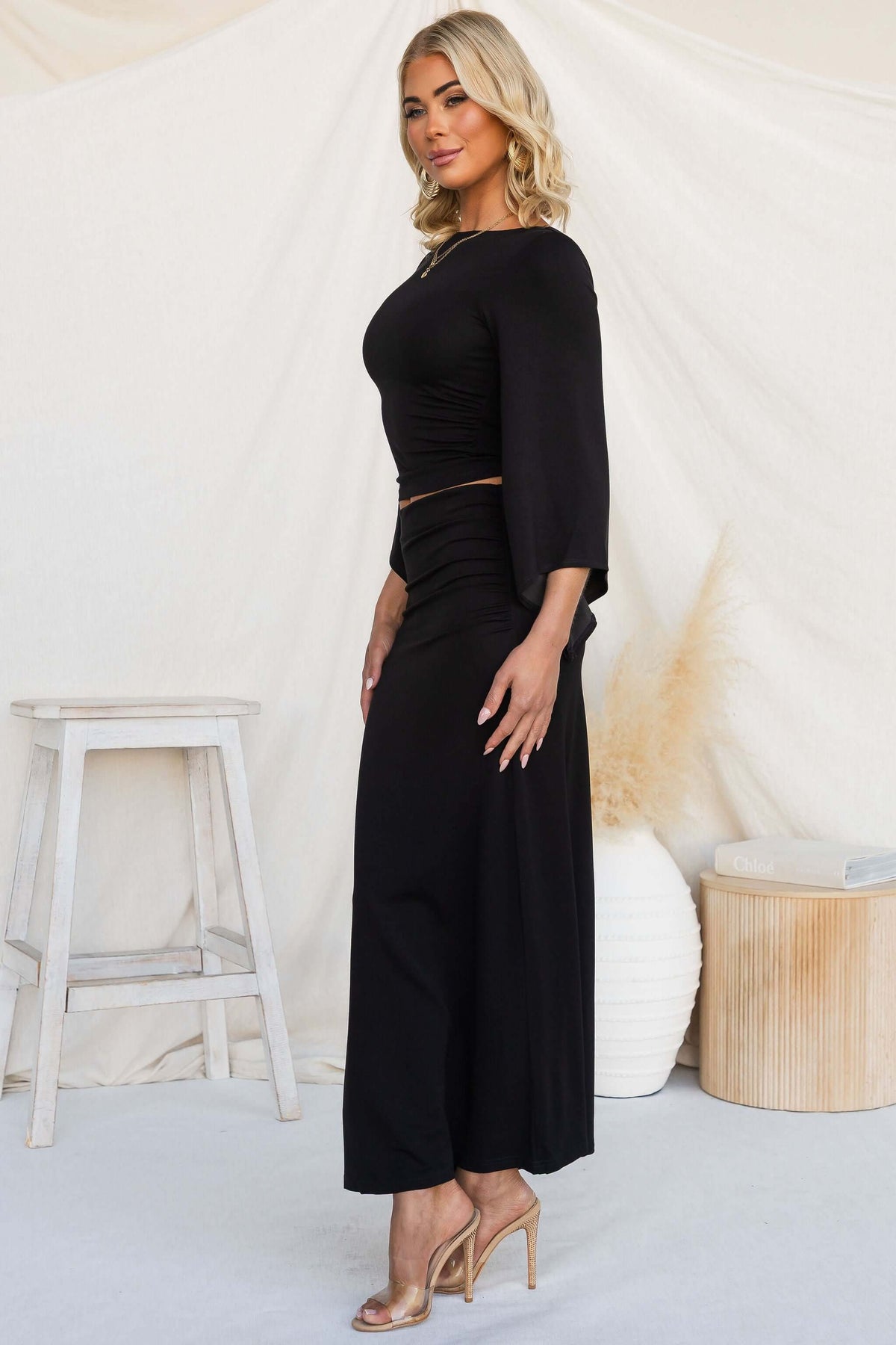 Model wearing the Maria Set with a round neckline and cape sleeves, showcasing the skirt's mid-high waist fit.
