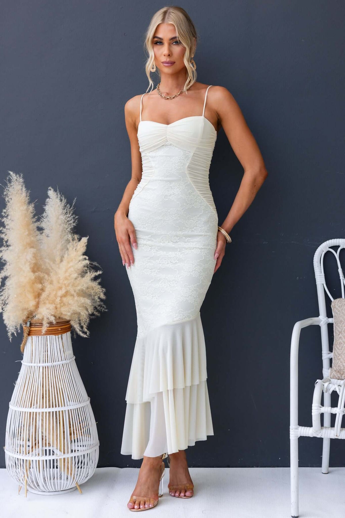 Model wearing Marilou Maxi Dress with lace detailing and adjustable straps, styled in a chic setting.