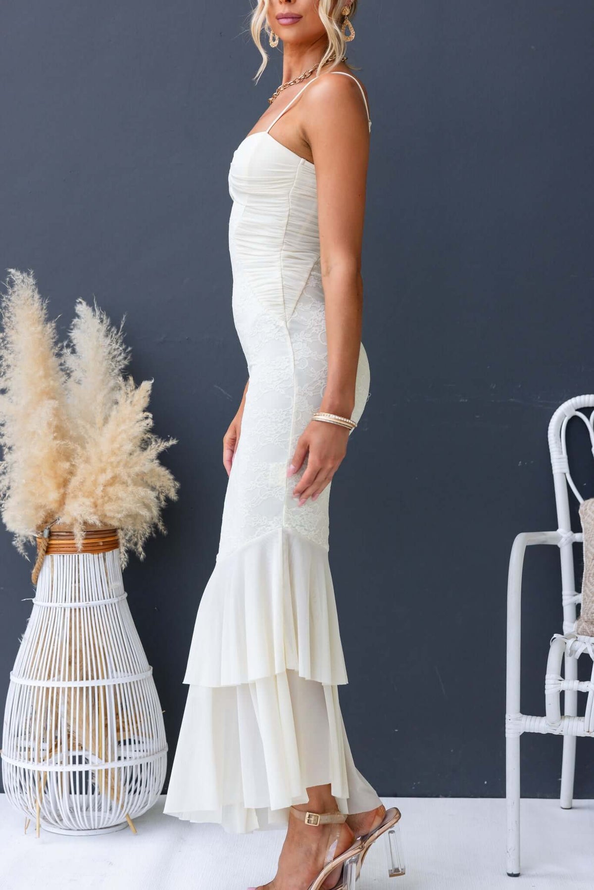 Model in a Marilou Maxi Dress with adjustable straps and lace detailing, paired with stylish heels.