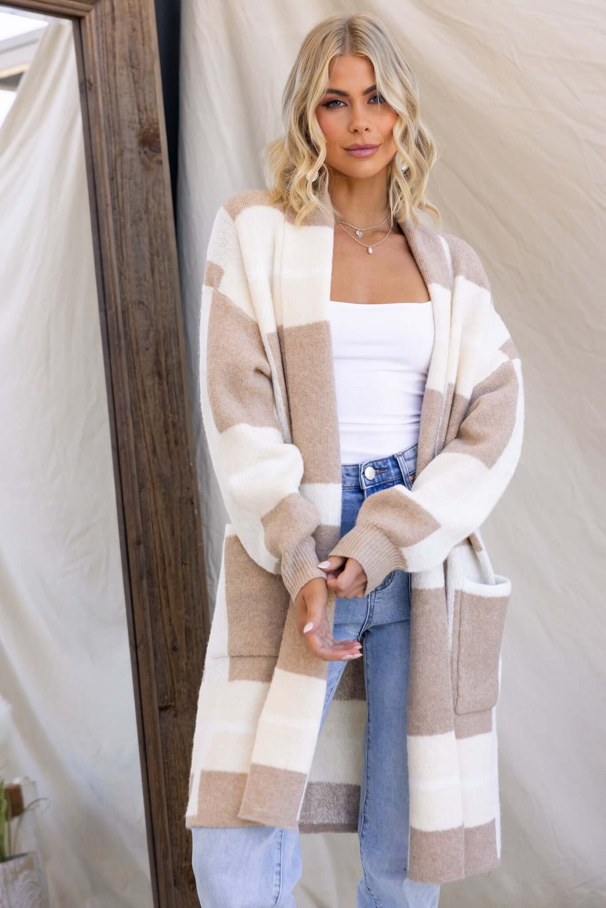 Mason Cardigan featuring a relaxed fit, pockets, knit material with a stylish collar in beige and white stripes.