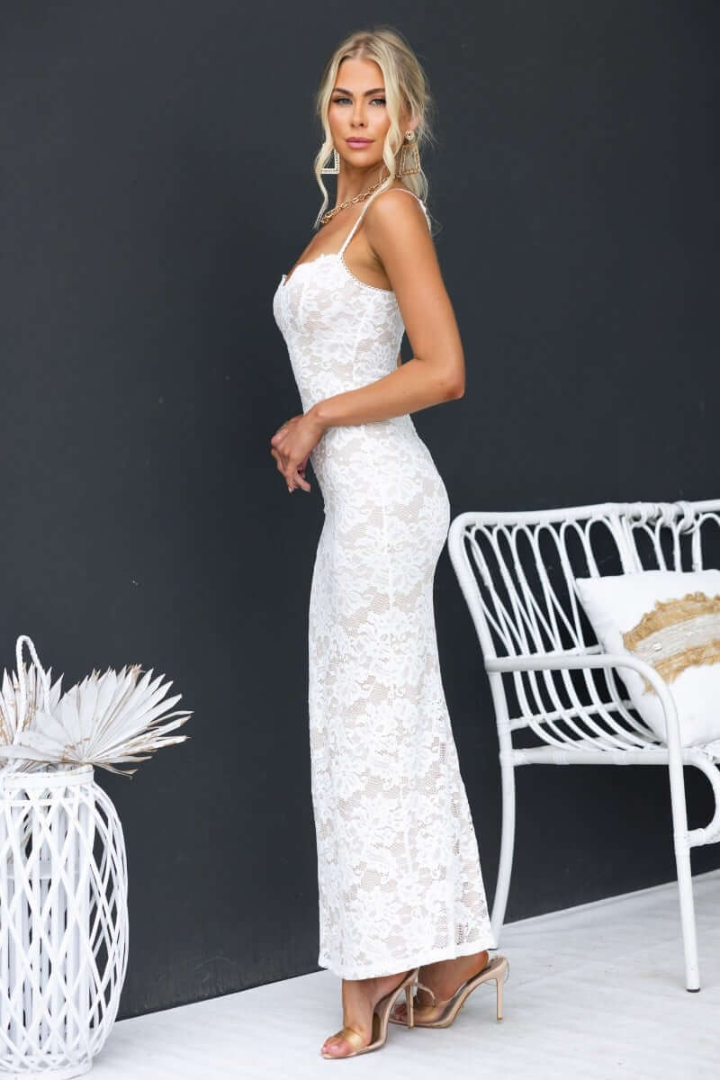 Chic white lace maxi dress with adjustable straps, featuring a fitted silhouette and elegant design, perfect for special occasions.