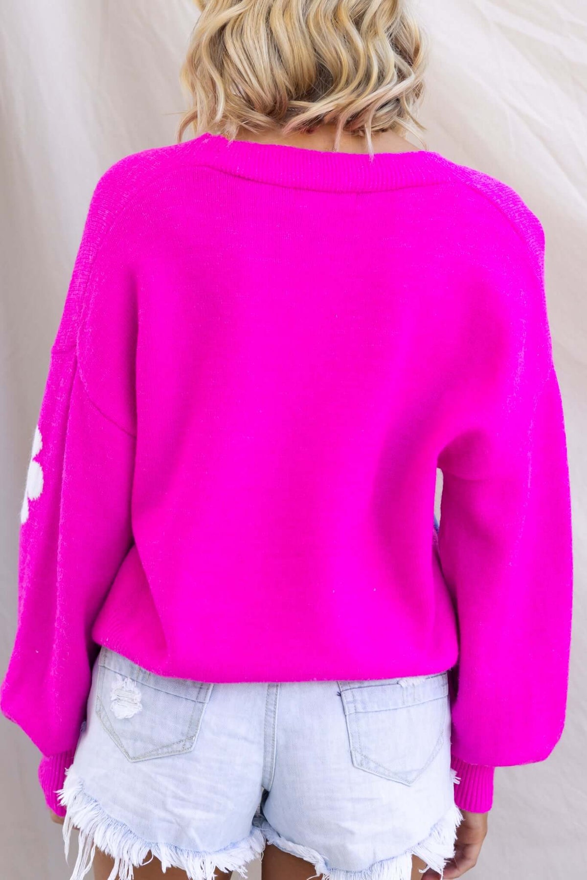 Mimsie Cardigan in vibrant pink, featuring a relaxed fit and cozy knit material, perfect for stylish layering.