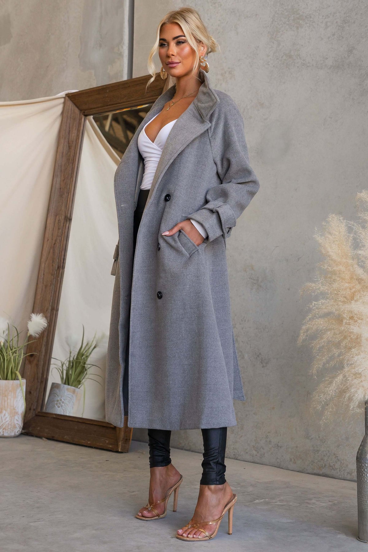 Modern Love Coat displayed on model featuring a funnel neck, button closure, and pockets in a stylish setting.