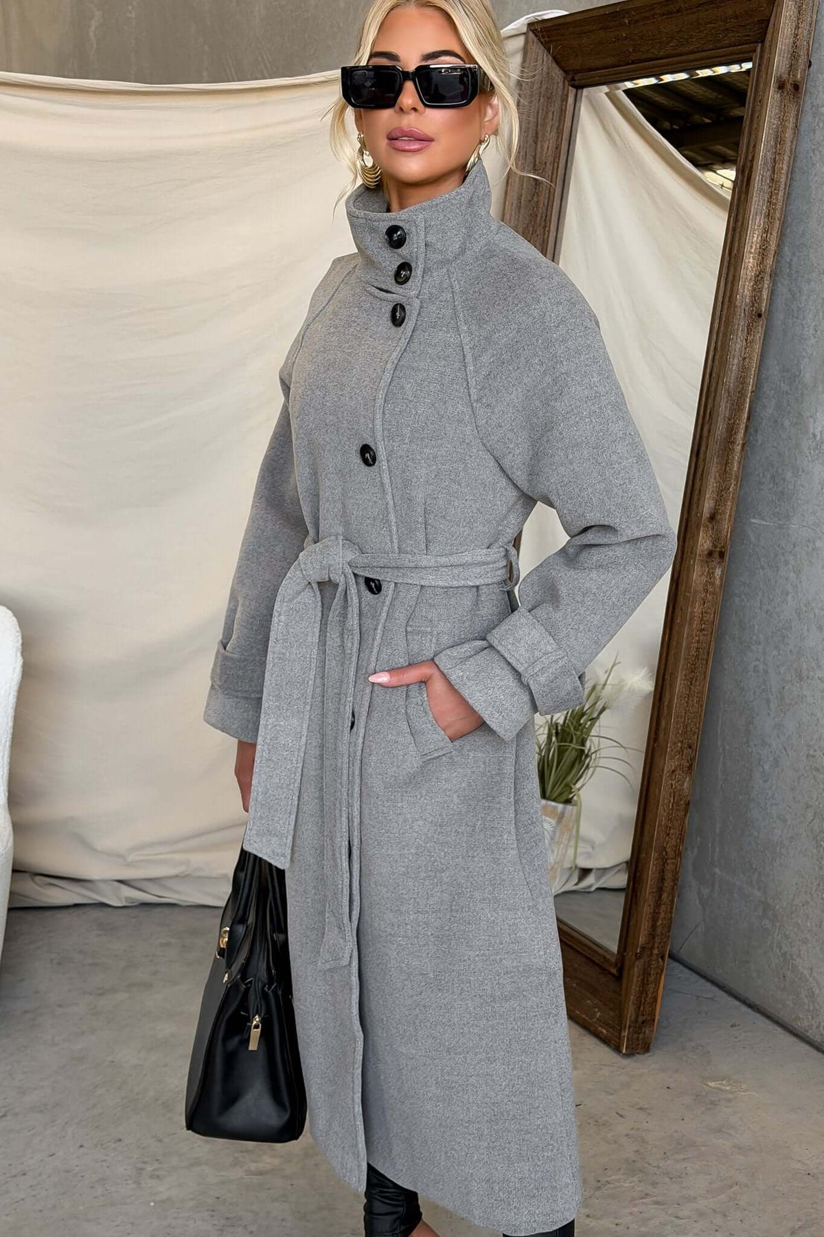 Model wearing Modern Love Coat with funnel neck, button closure, and removable belt in grey.
