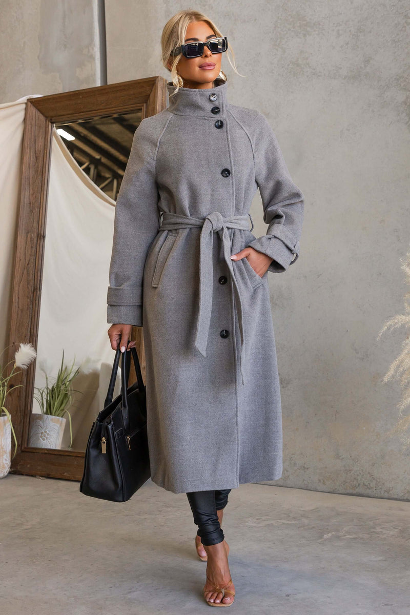 Model wearing the Modern Love Coat with funnel neck and removable belt, accessorized for a chic look.