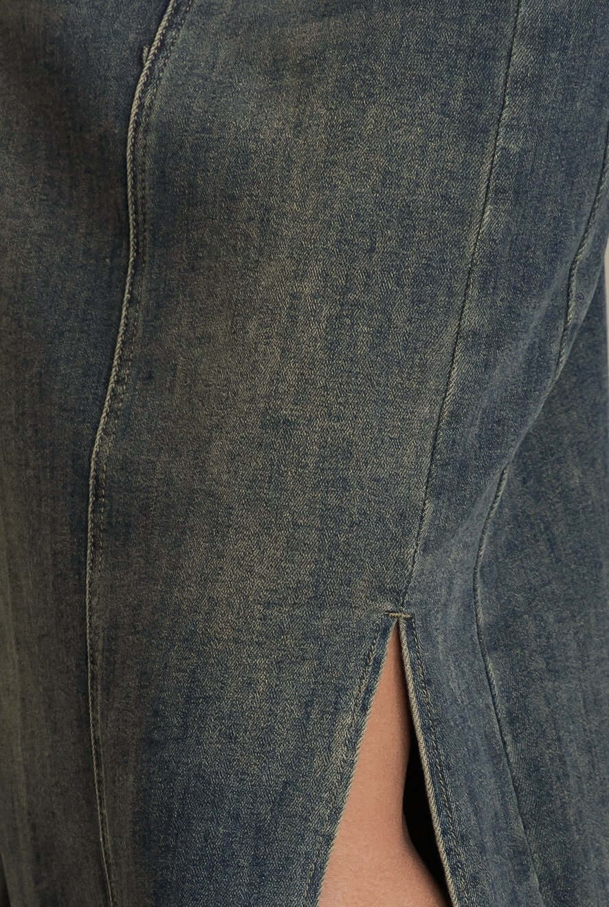 Close-up of split detail on Moon Denim Midi Skirt showcasing denim texture and color variation.