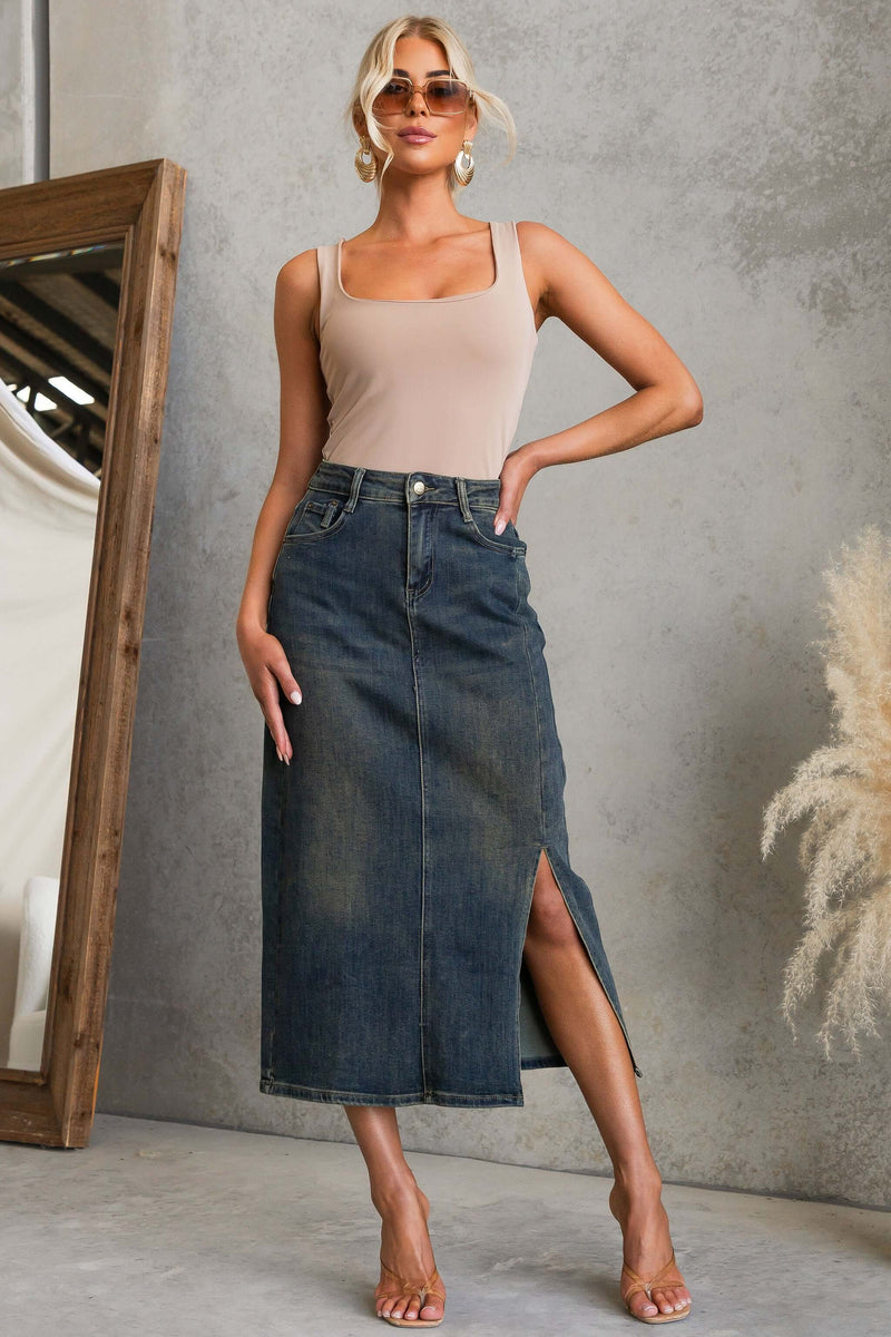 Model showcasing the Moon Denim Midi Skirt with a front split and pockets in a chic, urban setting.