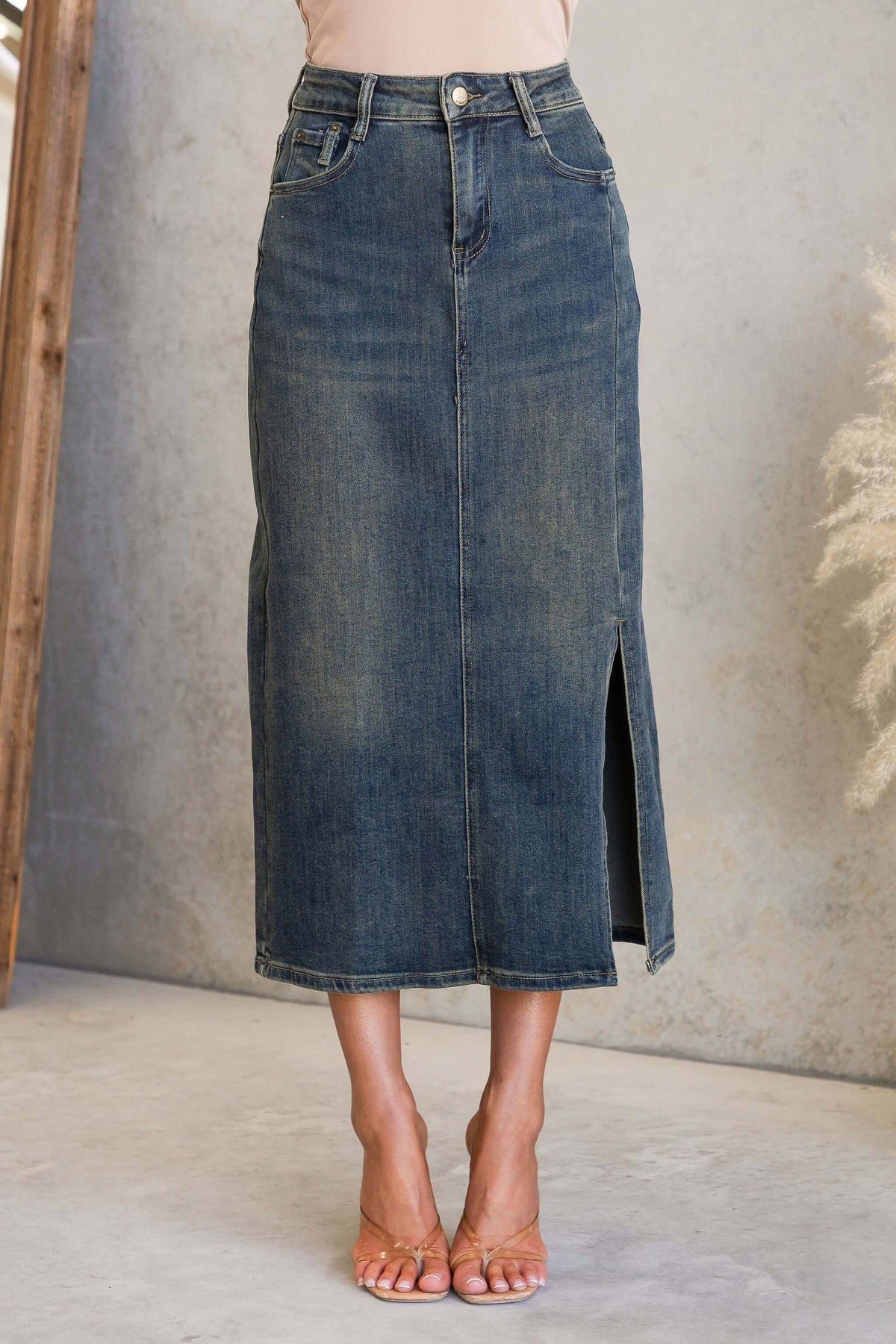 Moon Denim Midi Skirt displayed with a front split and mid-high waist fit, featuring pockets and a denim texture.