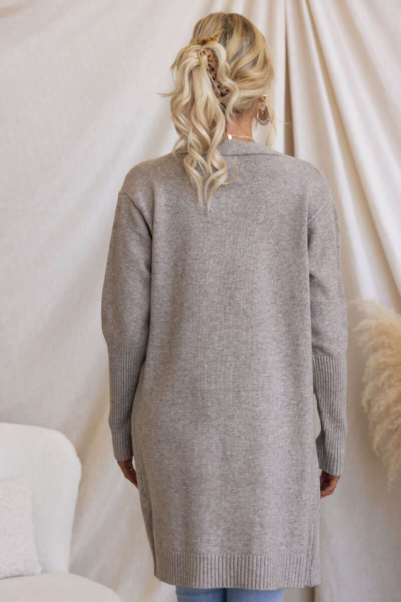 Back view of a longline ribbed knit Motherly Cardigan in light gray, showcasing its relaxed fit and cozy design.