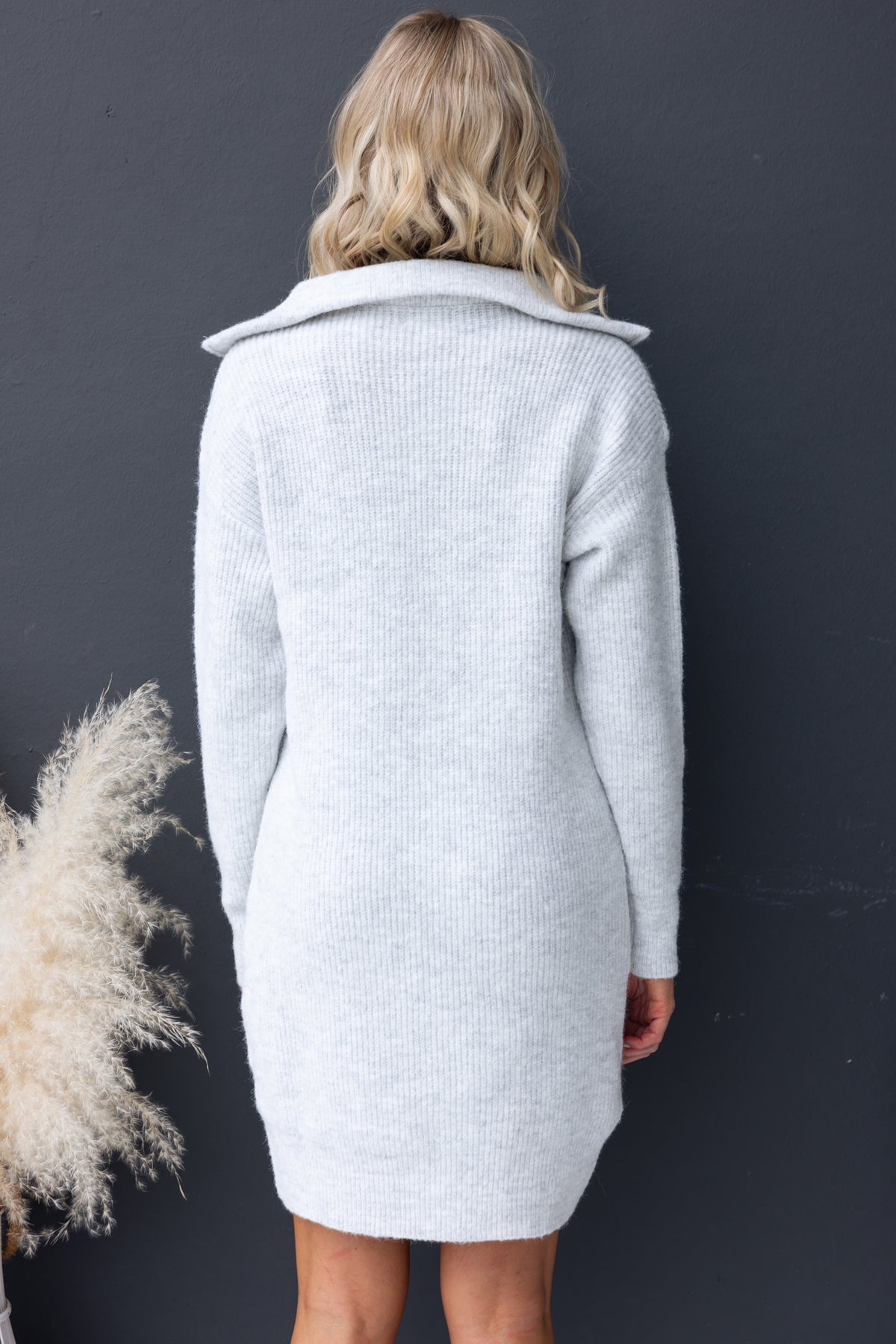Back view of Nayeli Dress in soft grey knit with 1/4 zip collar and relaxed fit, showcasing stretch material.