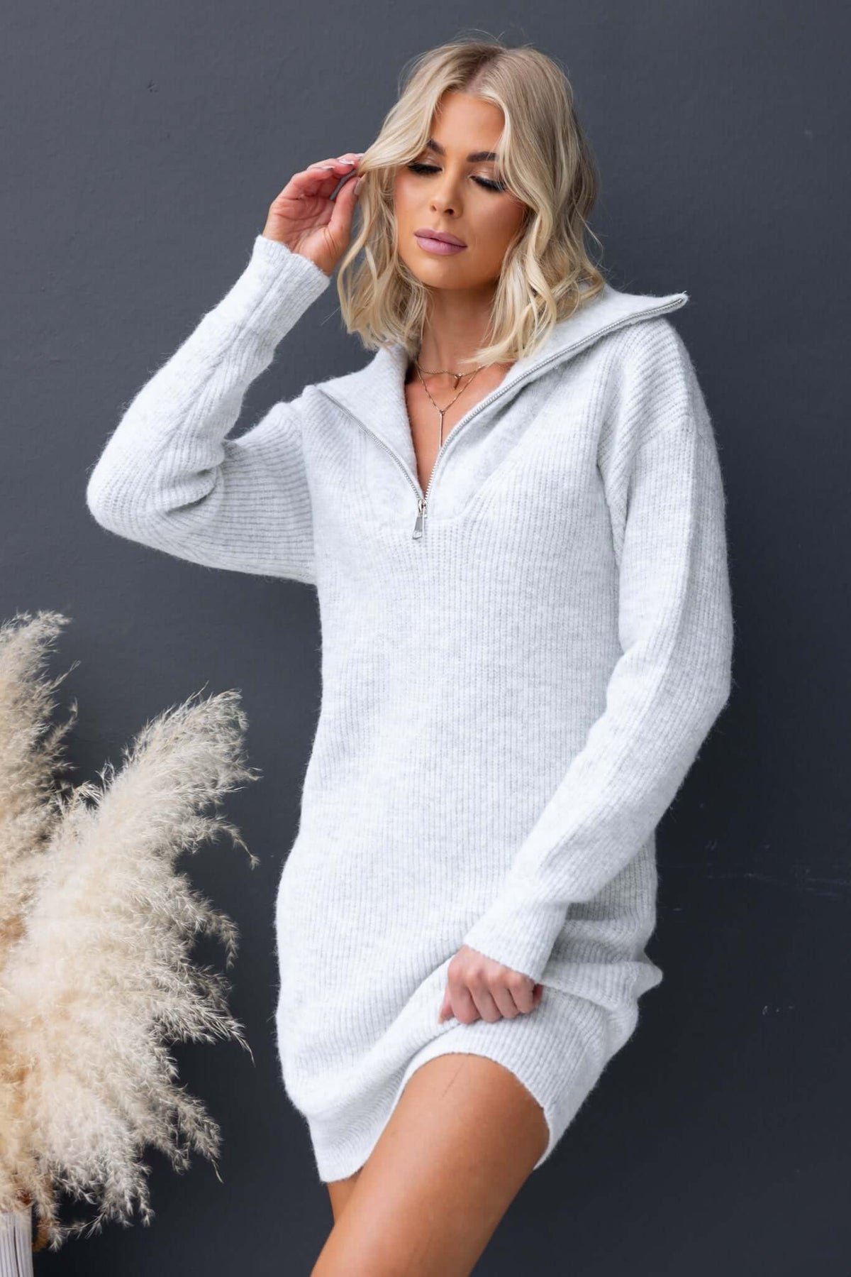 Nayeli Dress showcasing a stylish knit design with 1/4 zip collar, perfect for a relaxed fit in soft, ribbed material.