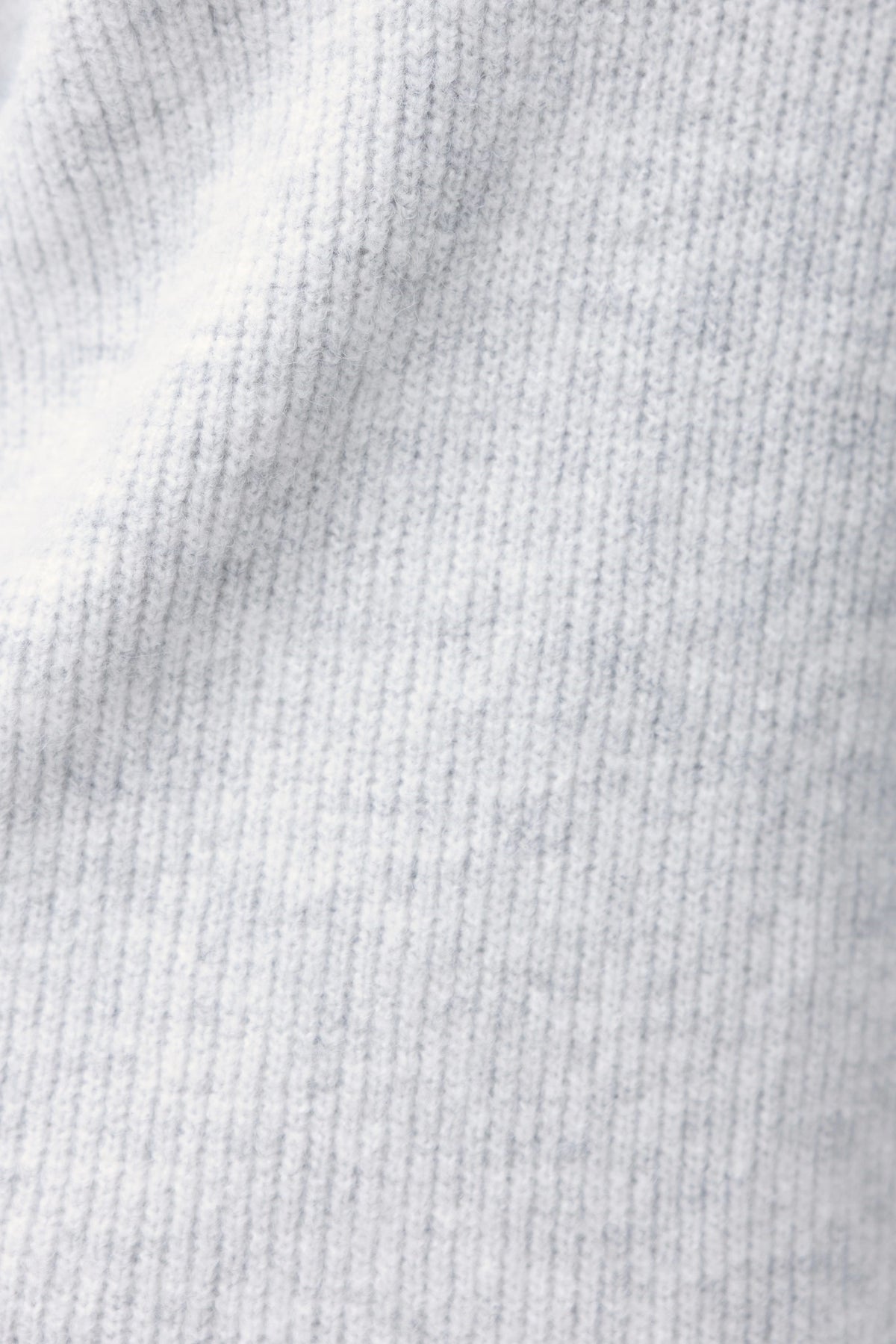 Close-up of Nayeli Dress's knit ribbed material in light gray with subtle blue stripes, showcasing its soft texture.