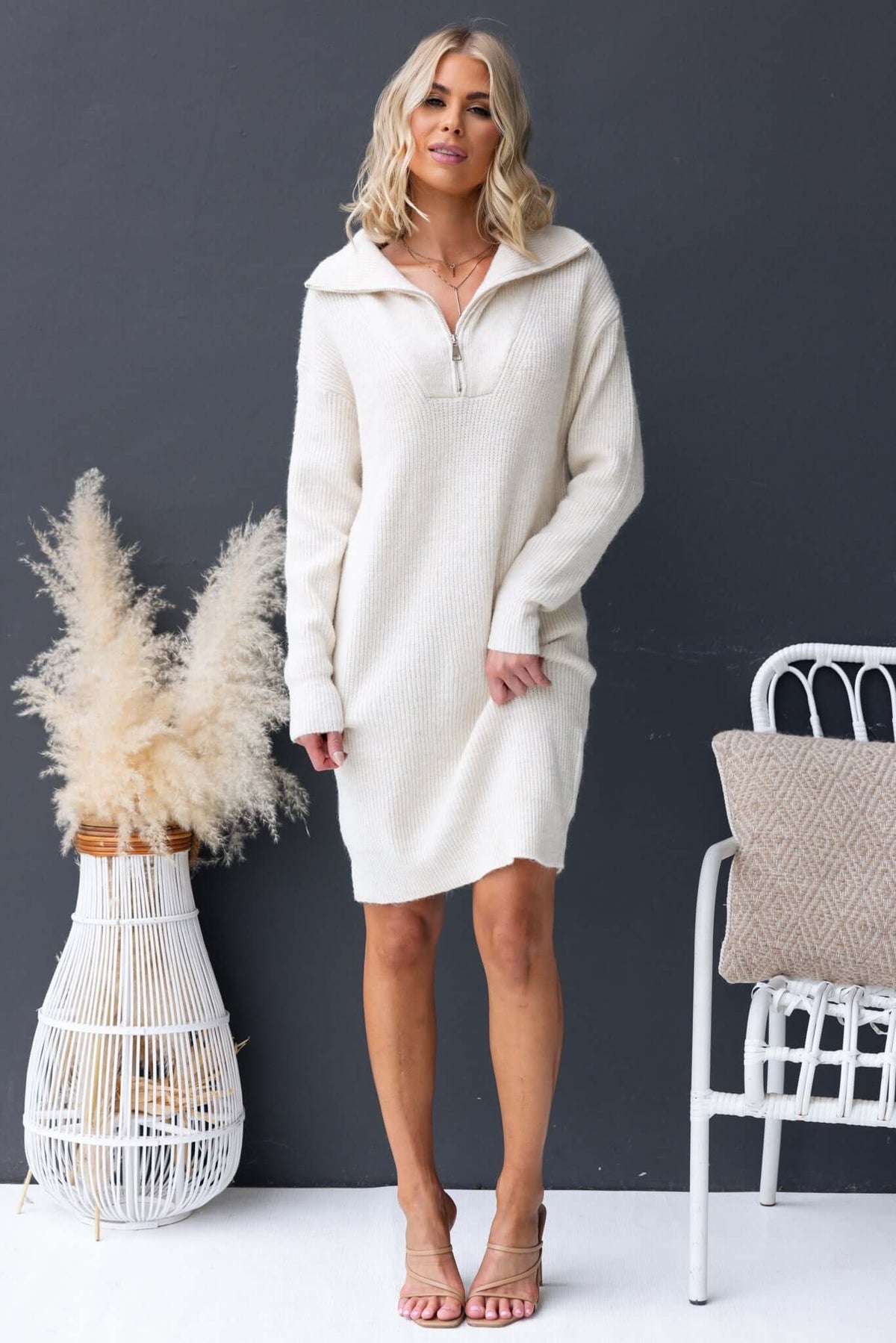 Taylah wearing the Nayeli Dress, a relaxed fit, knit ribbed dress with a 1/4 zip collar in cream color.