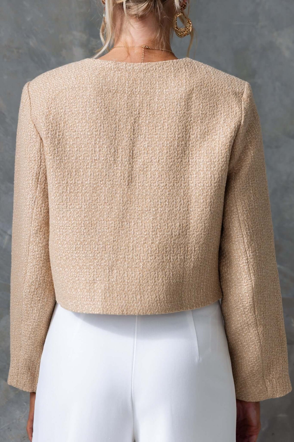 Back view of Noelle Jacket in beige chenille fabric, featuring a cropped design and tailored fit, perfect for stylish layering.