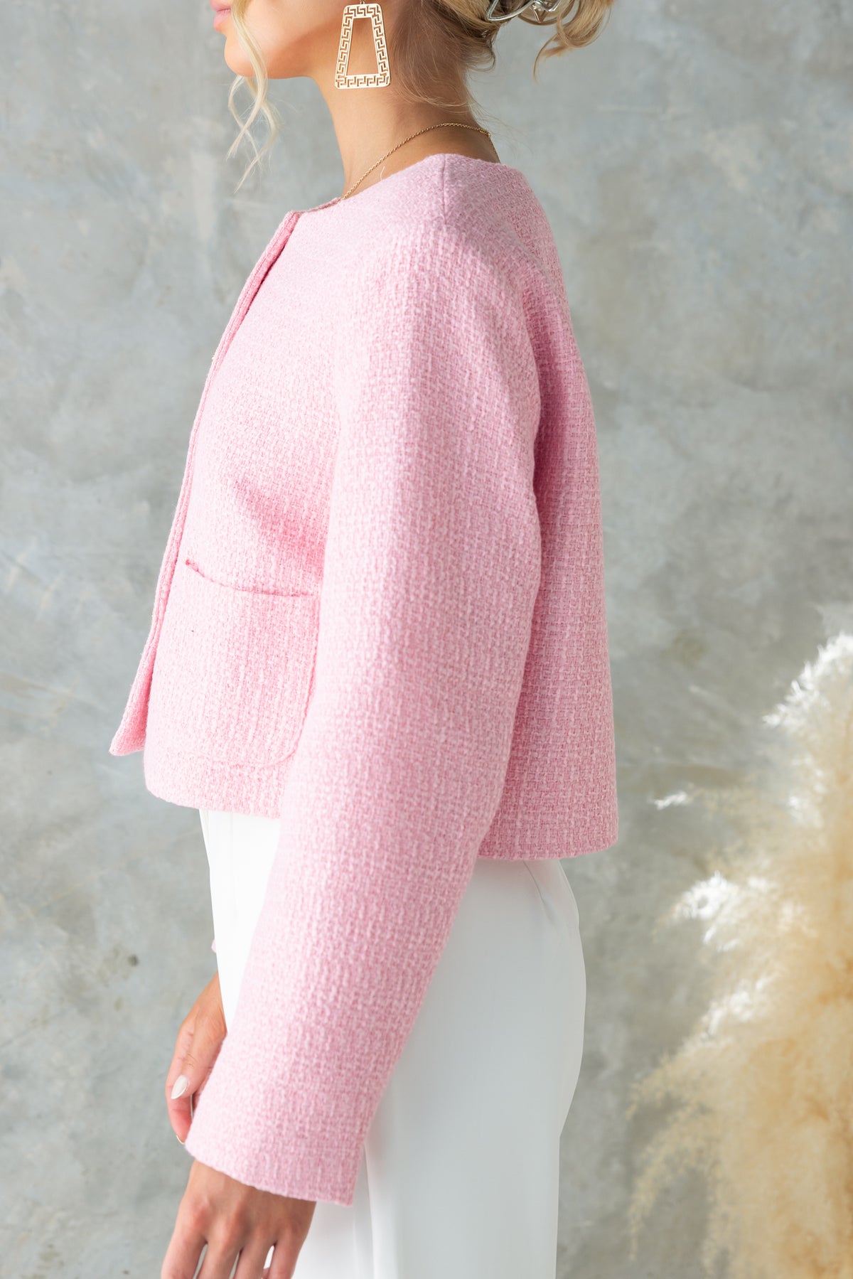 Noelle Jacket in soft pink chenille fabric with button-up front and shoulder pads, worn by a model with earrings.