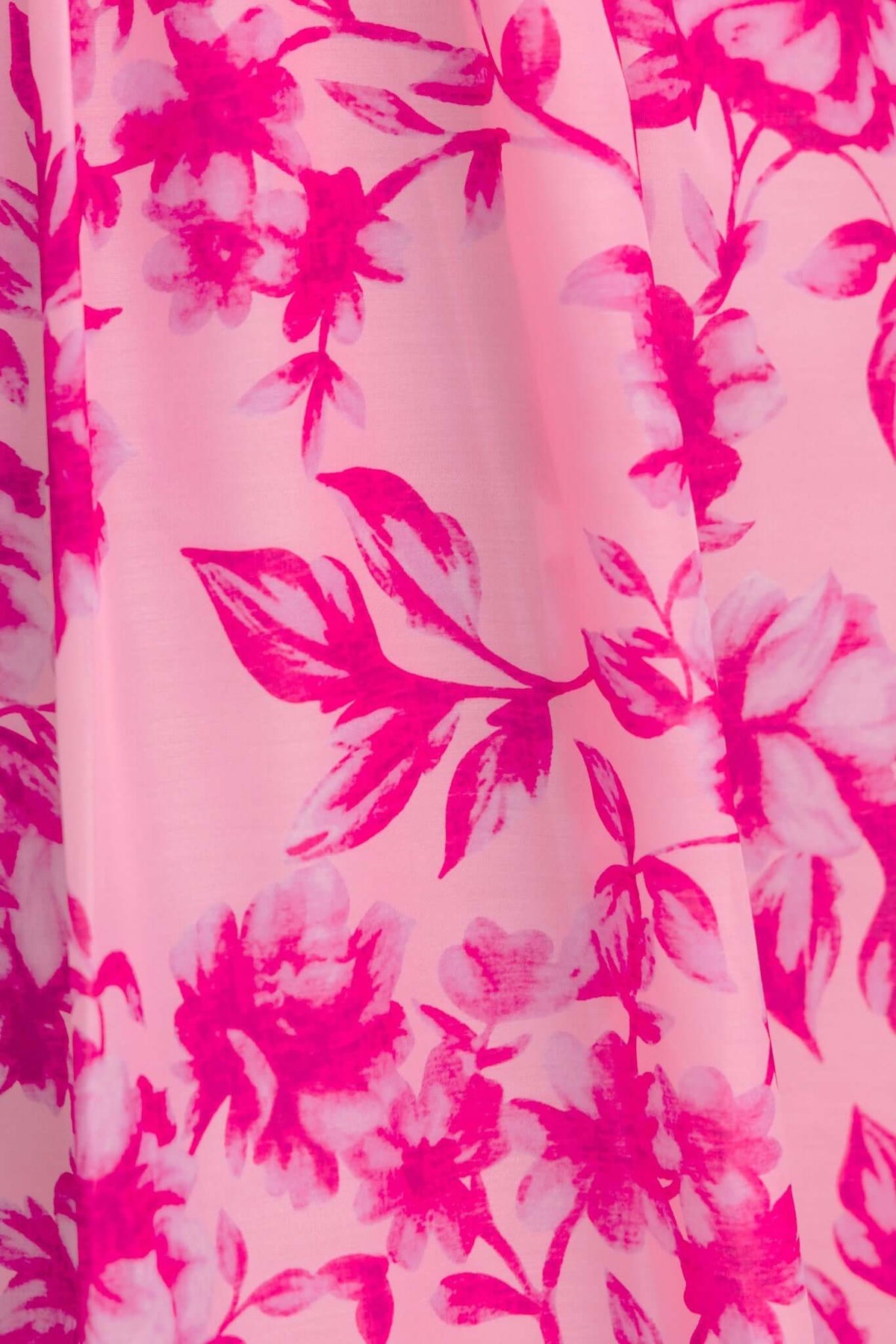 Okansa Maxi Dress featuring a vibrant pink floral pattern on lightweight fabric, perfect for summer occasions.