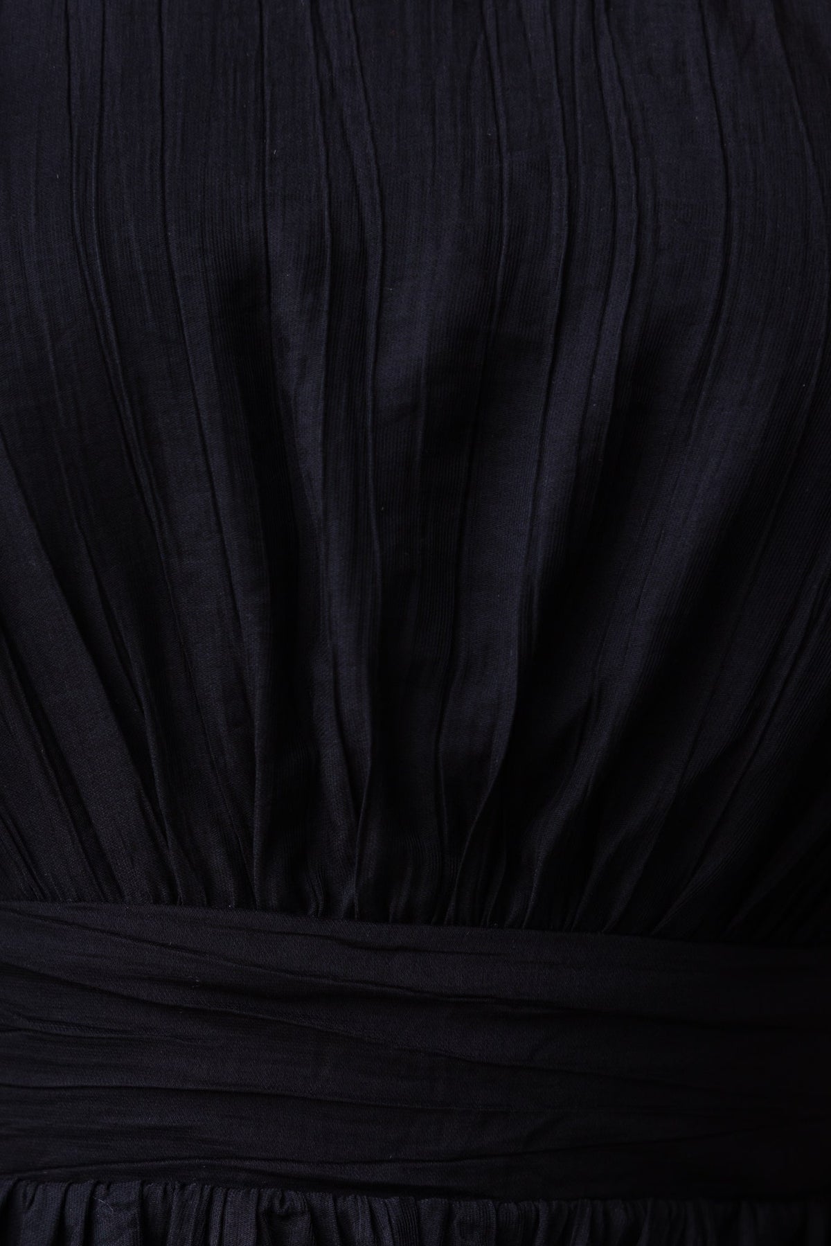 Close-up of the black Orsini Dress fabric showing pleats and elastic waistband, ideal for a stylish and comfortable fit.