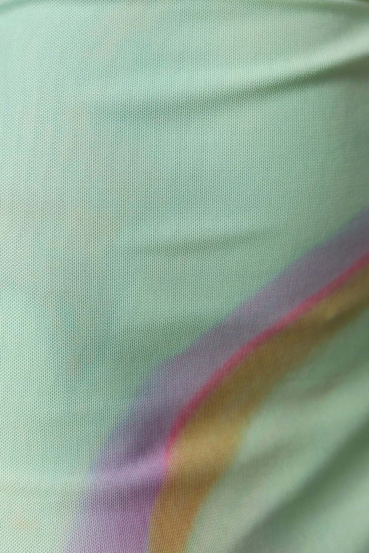 Close-up of mesh fabric in mint green with colorful gradient accents, perfect for the Otelia Maxi Dress.