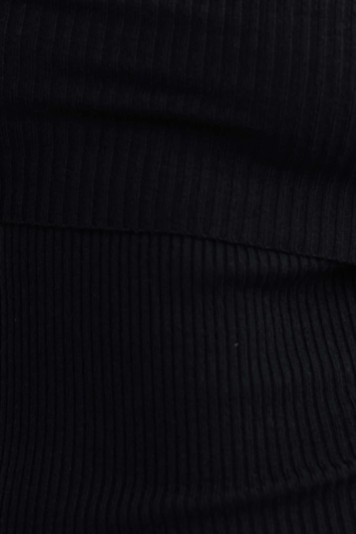 Close-up of ribbed knit fabric in black, showcasing texture ideal for the Oxnard Maxi Dress.