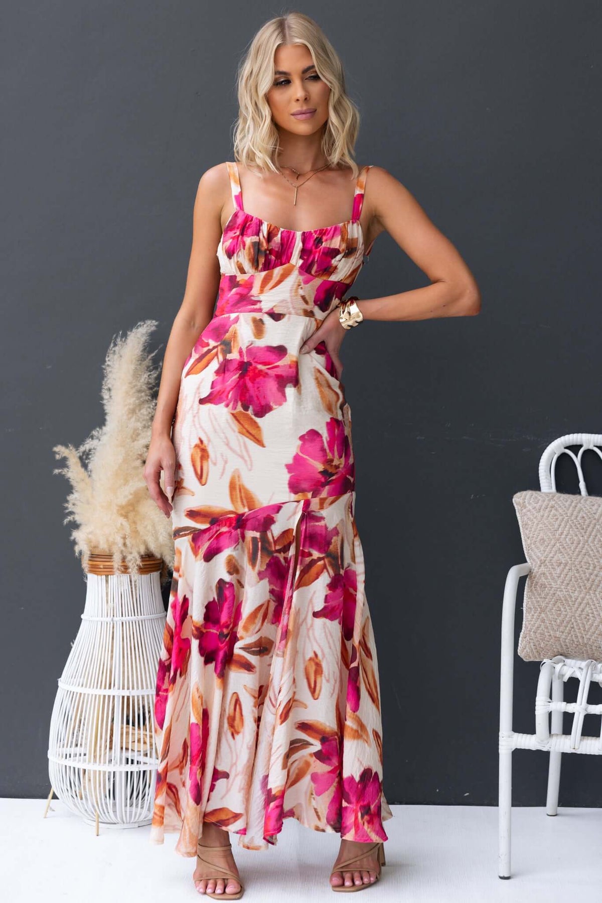 Model wearing an Ozias Maxi Dress in floral chiffon, featuring adjustable straps and front split.