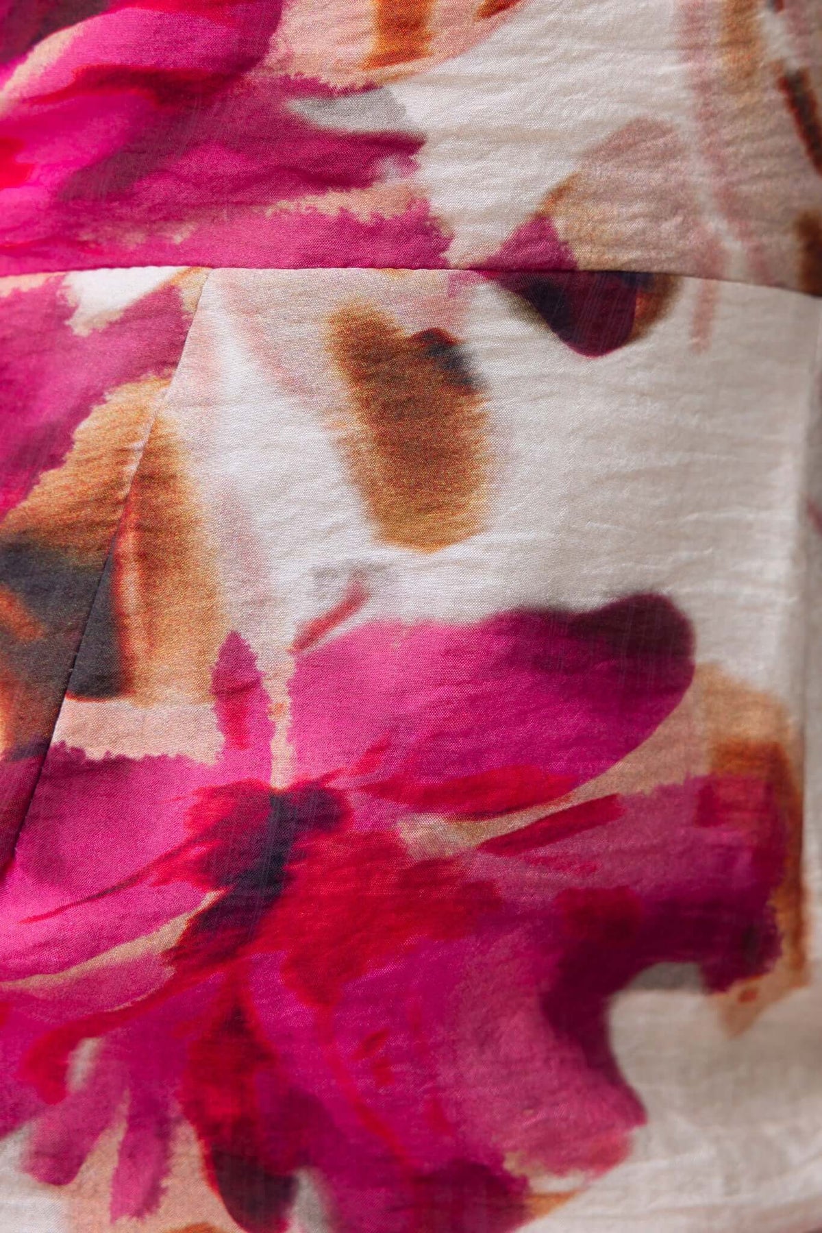 Close-up of floral pattern on Ozias Maxi Dress with vibrant pink and earthy tones.